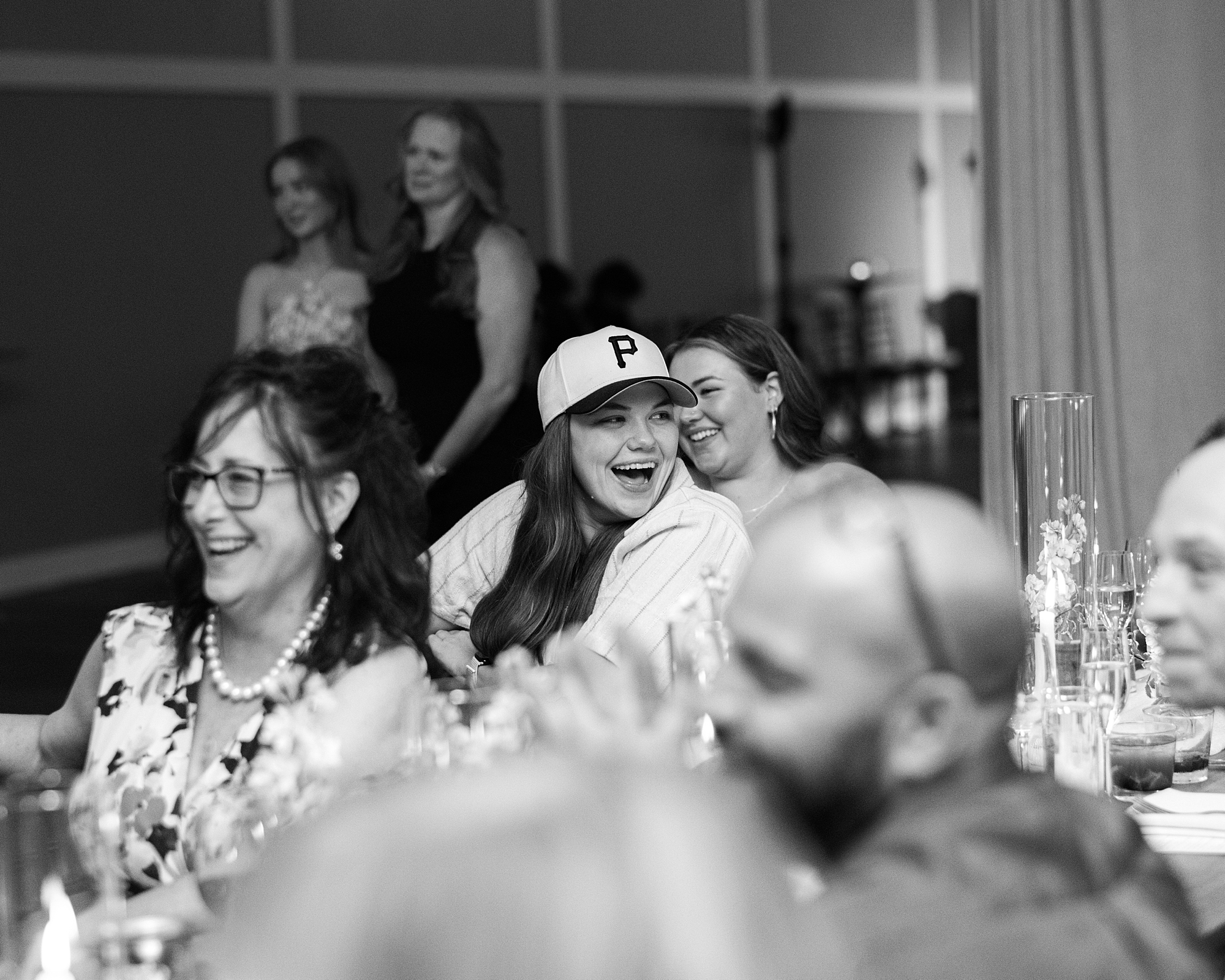 woman in baseball cap laughs during reception at Terrain Gardens