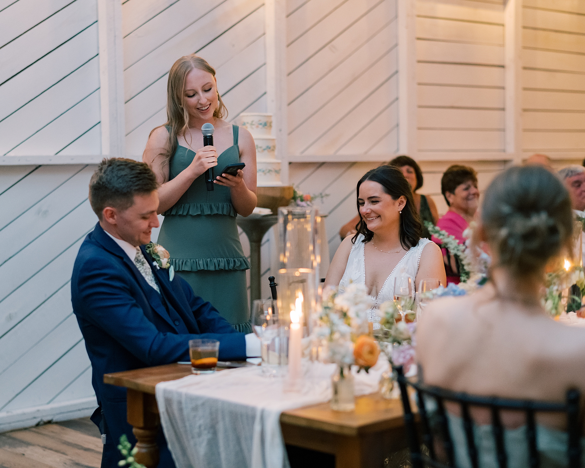 bridesmaid gives speech to bride and groom at Terrain Gardens