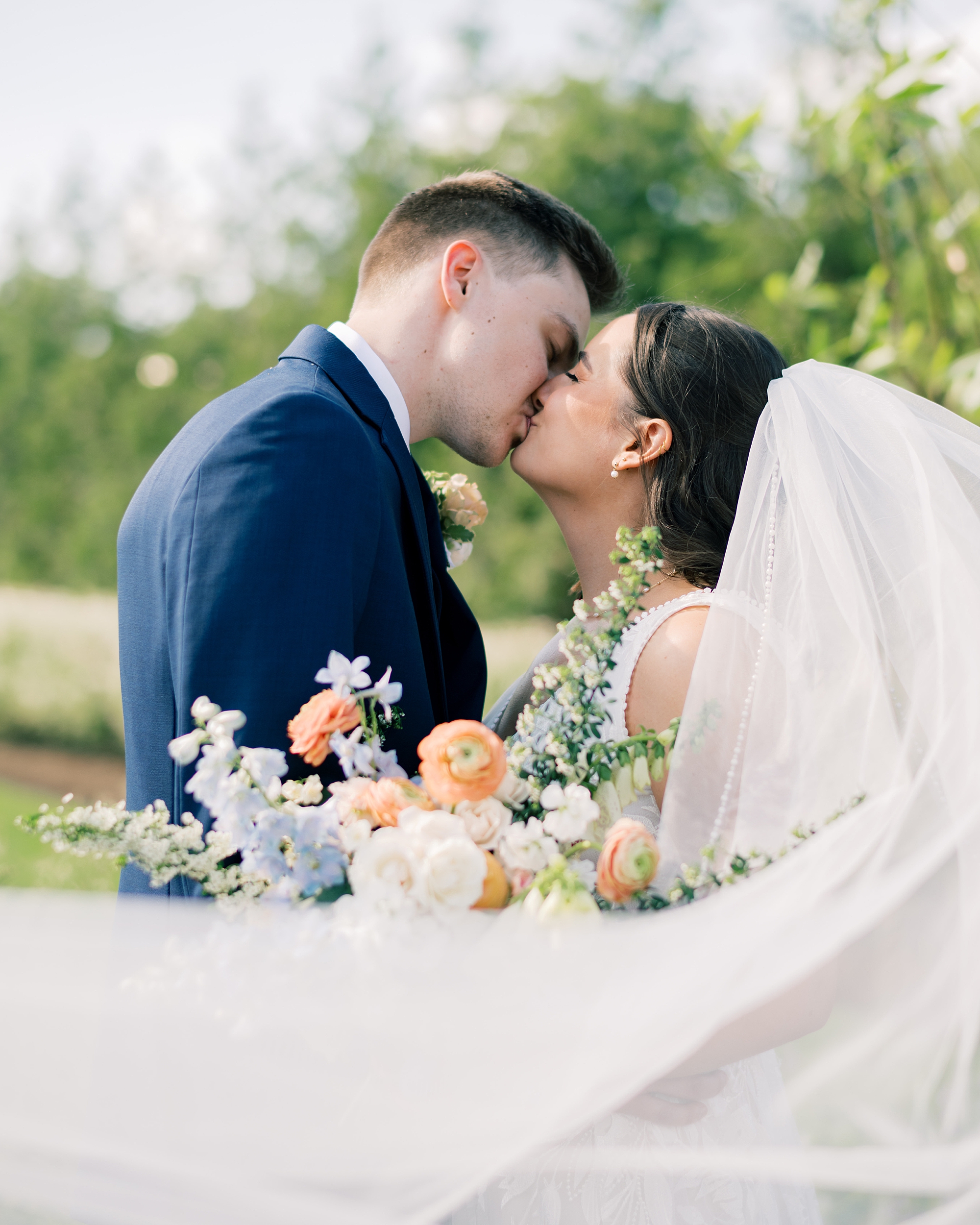 newlyweds kiss during wedding day at Terrain Gardens