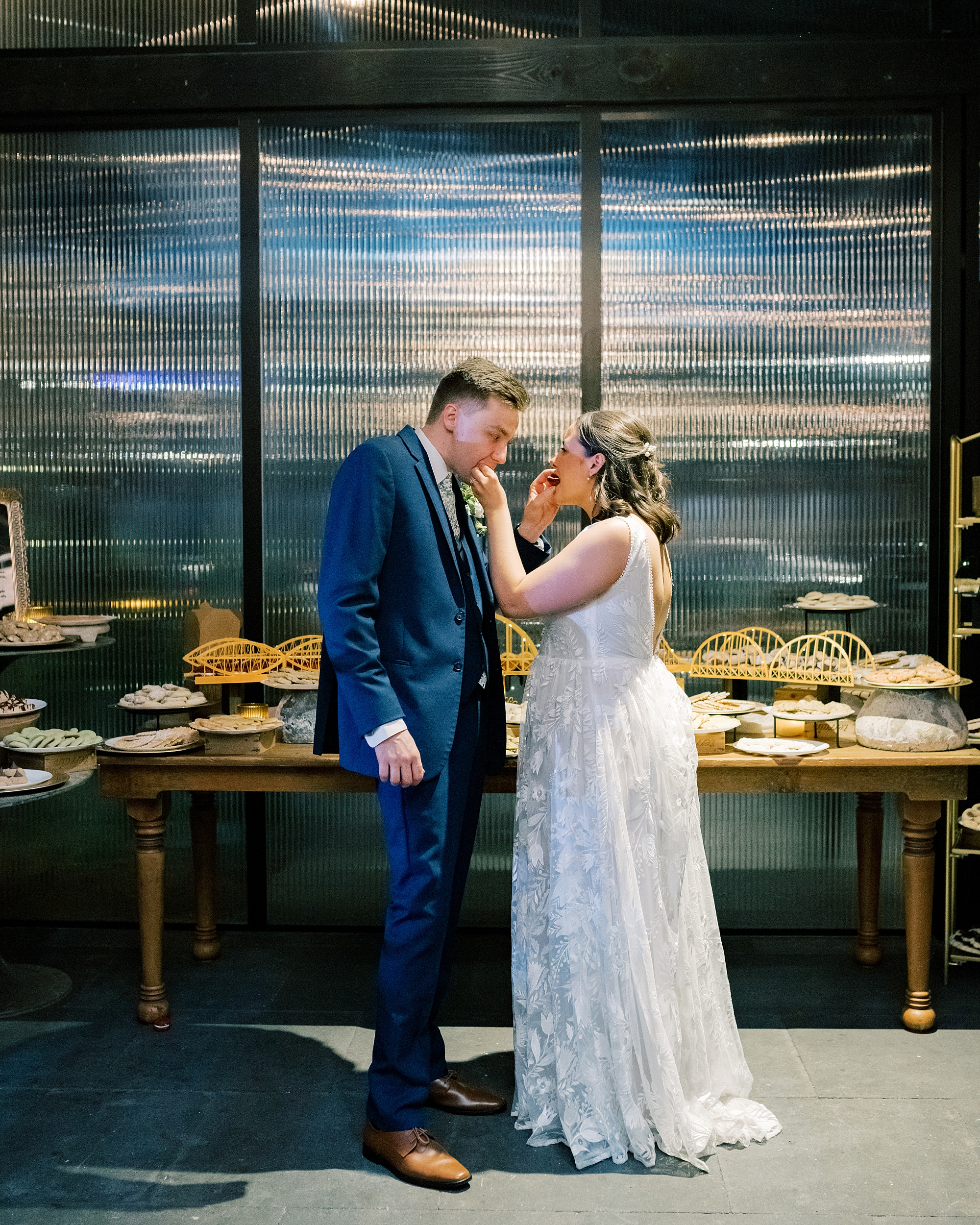 bride feeds groom cake at reception at Terrain Gardens