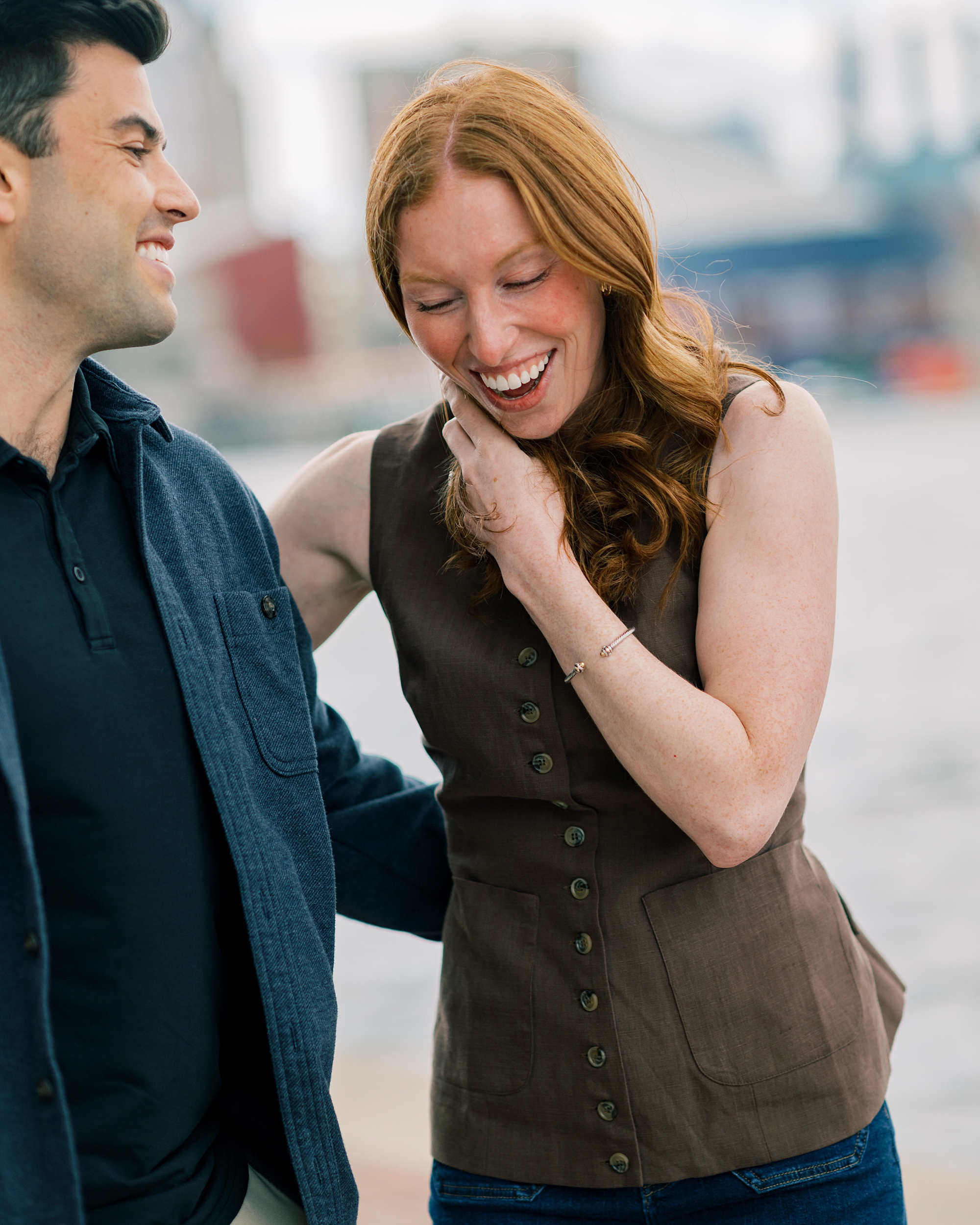 woman laughs with man after proposal in Baltimore Maryland