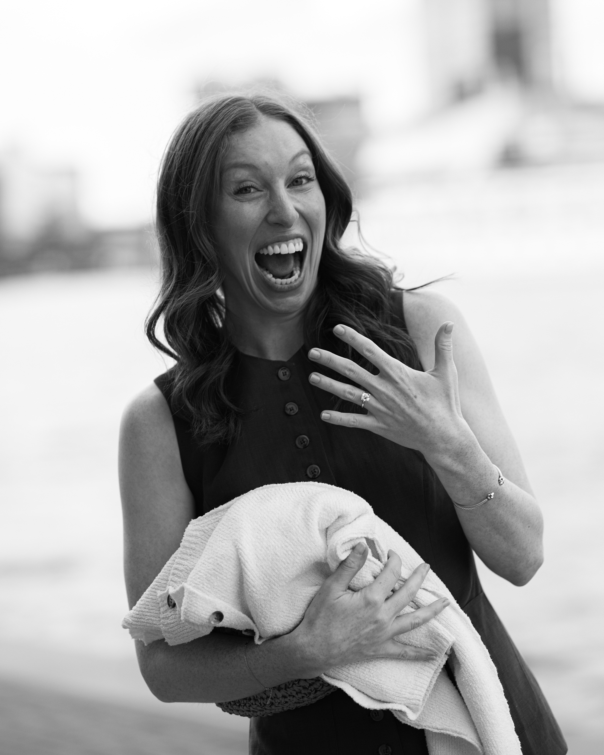 woman grins showing off engagement ring after proposal in Baltimore Maryland