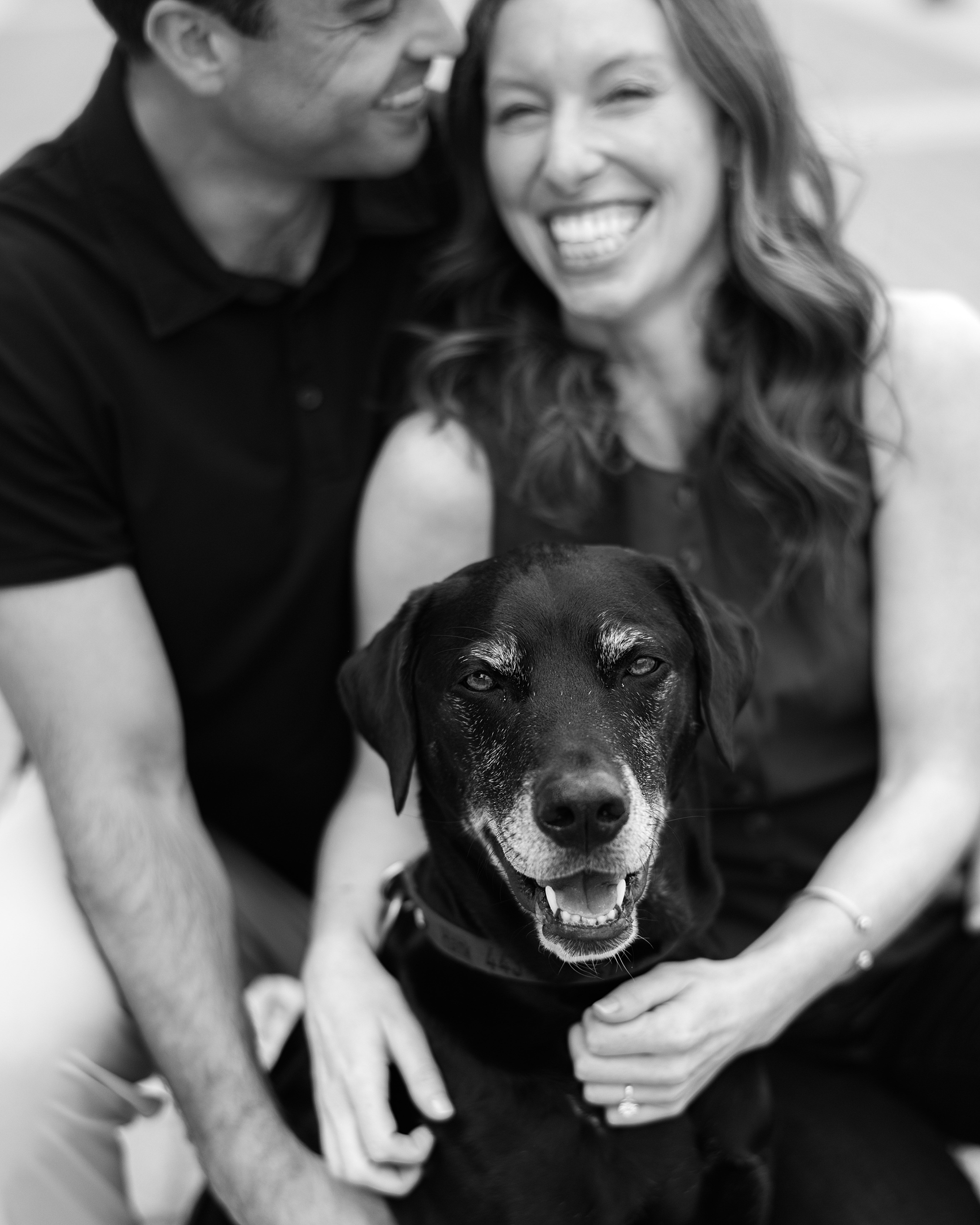 engaged couple hugs dog after proposal in Baltimore Maryland