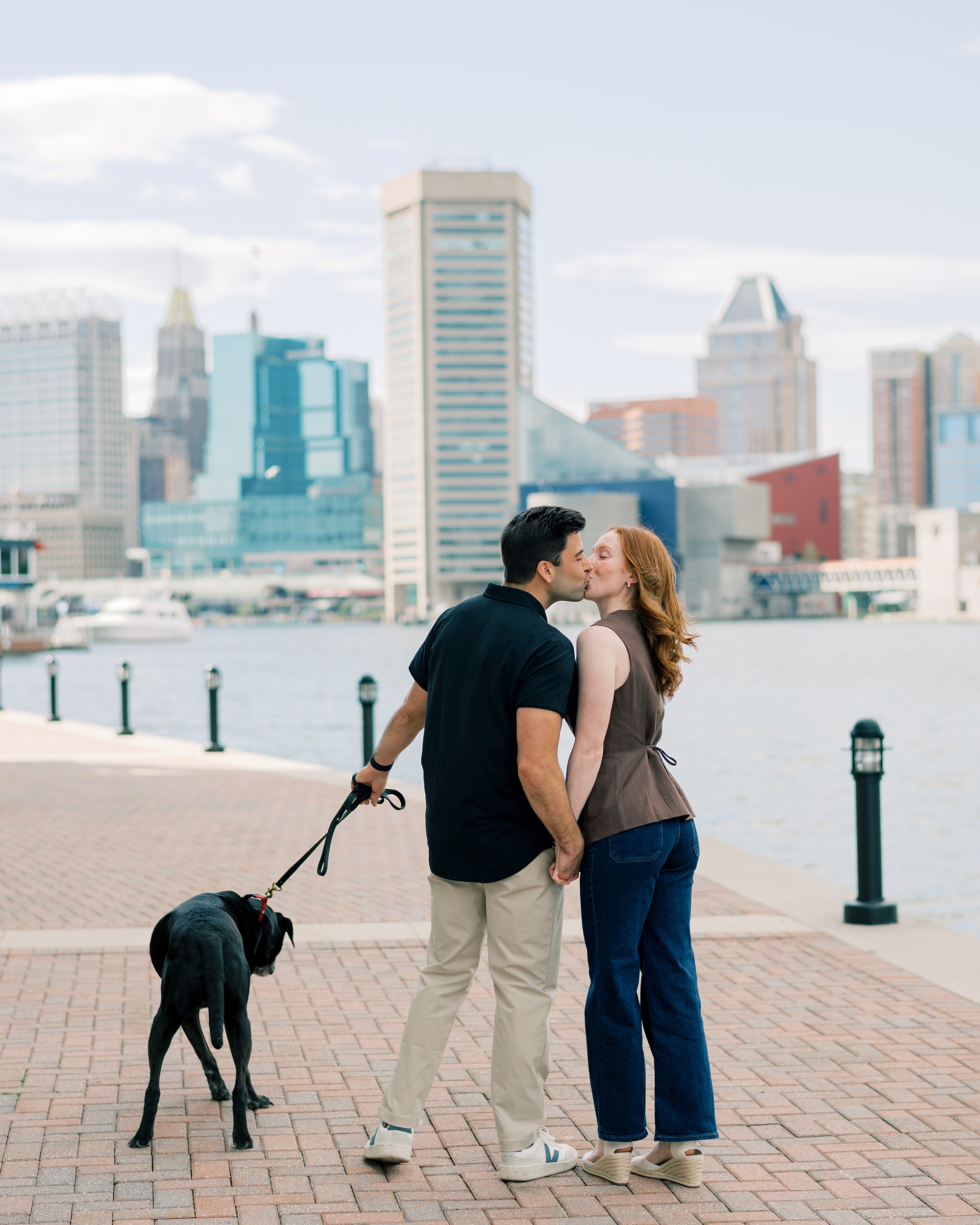 couple walks dog along Inner Harbor during surprise proposal in Baltimore Maryland