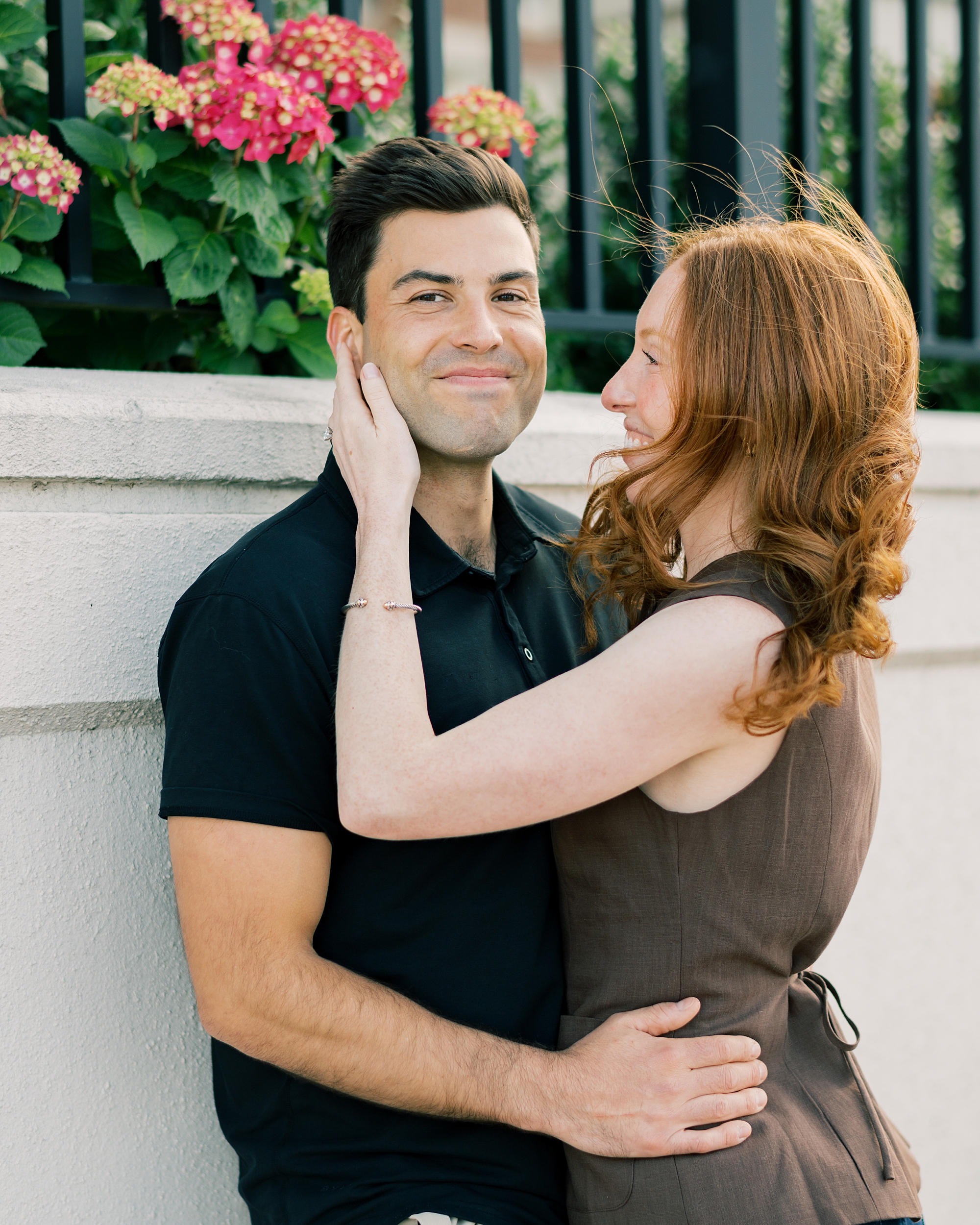 woman smiles at man hugging him during proposal in Baltimore Maryland