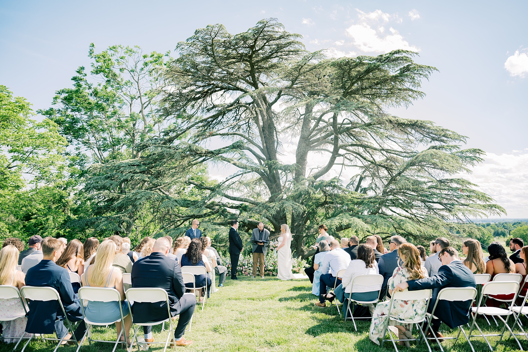 wedding ceremony under oak tree at Olde Breton Inn