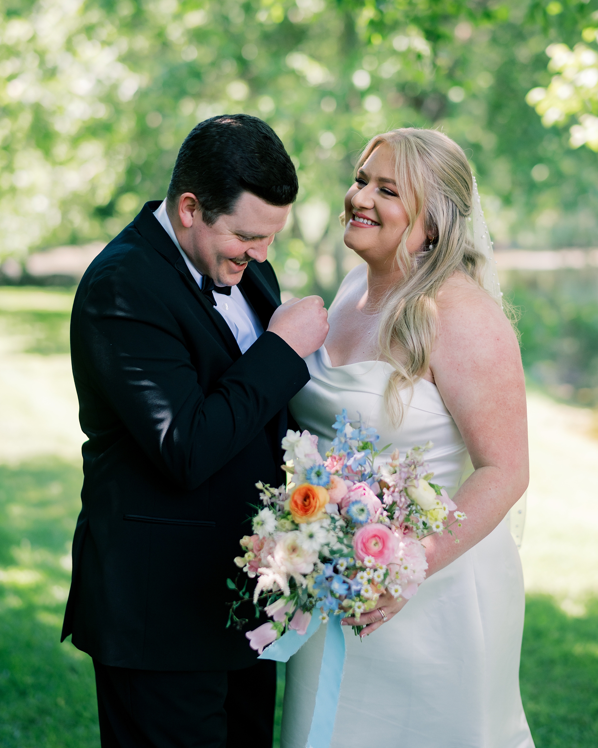 bride and groom laugh together during photos at Olde Breton Inn