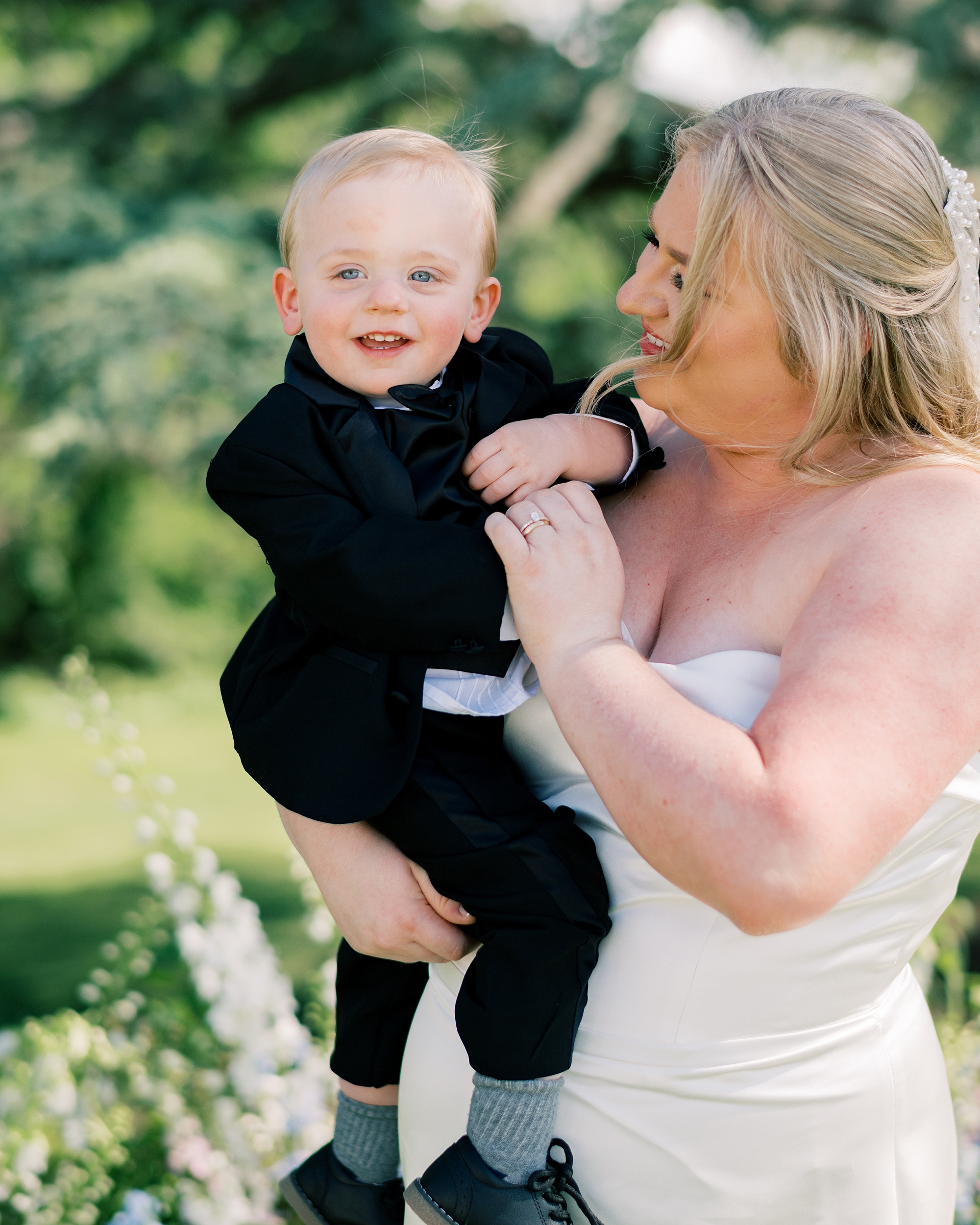 bride smiles with son on her hip at Olde Breton Inn