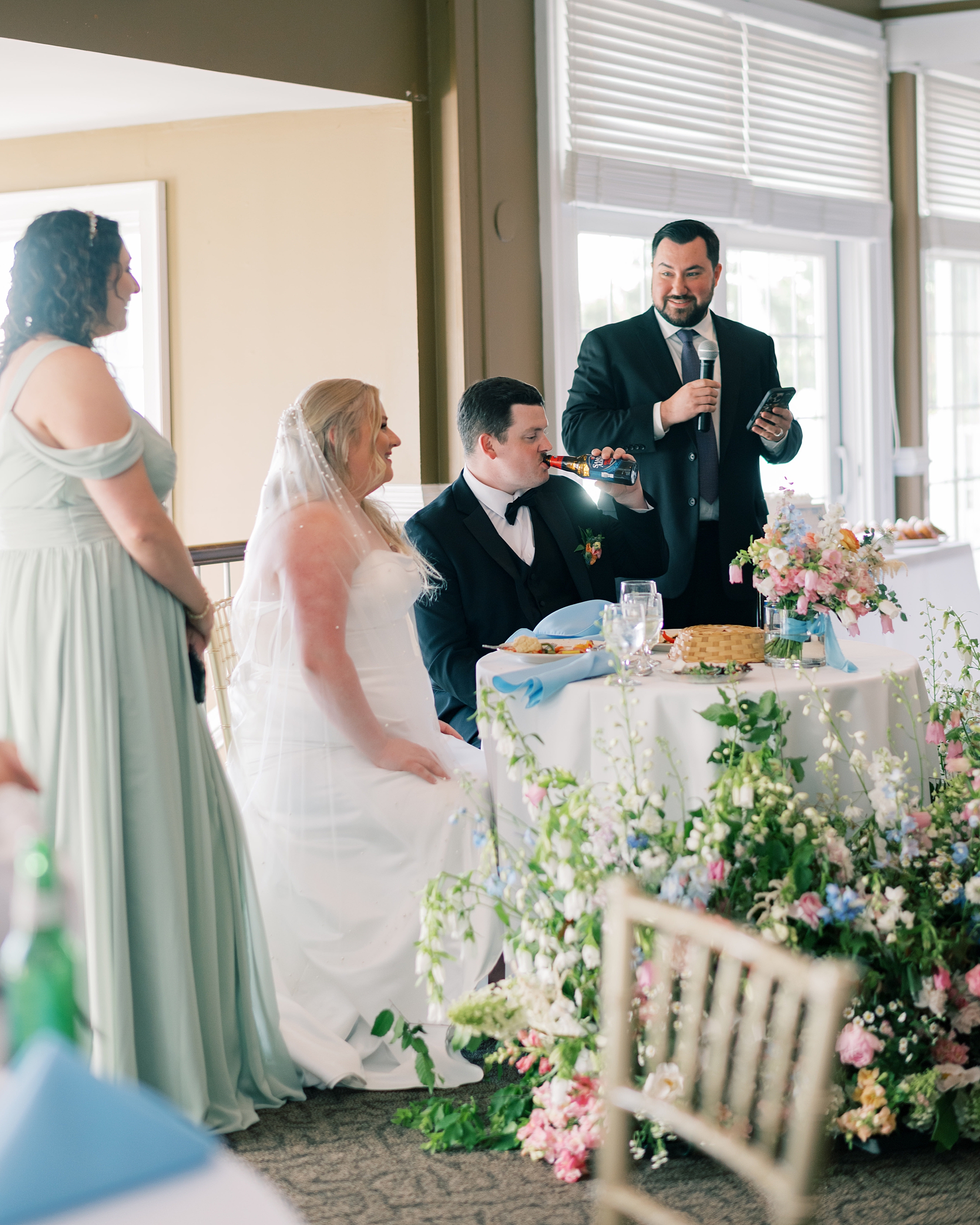 best man gives speech during wedding reception at Olde Breton Inn