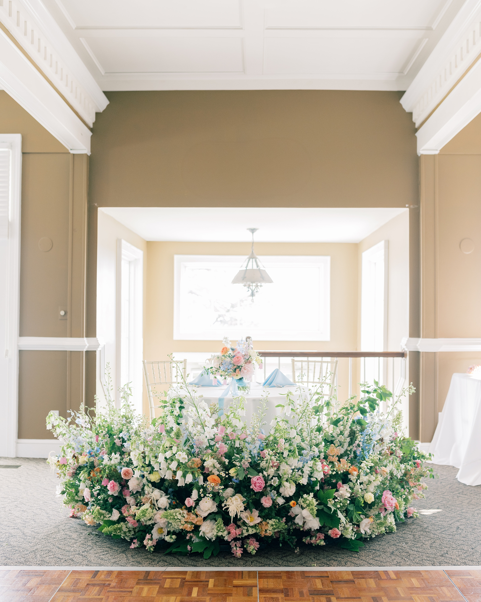spray of flowers in front of table at Olde Breton Inn