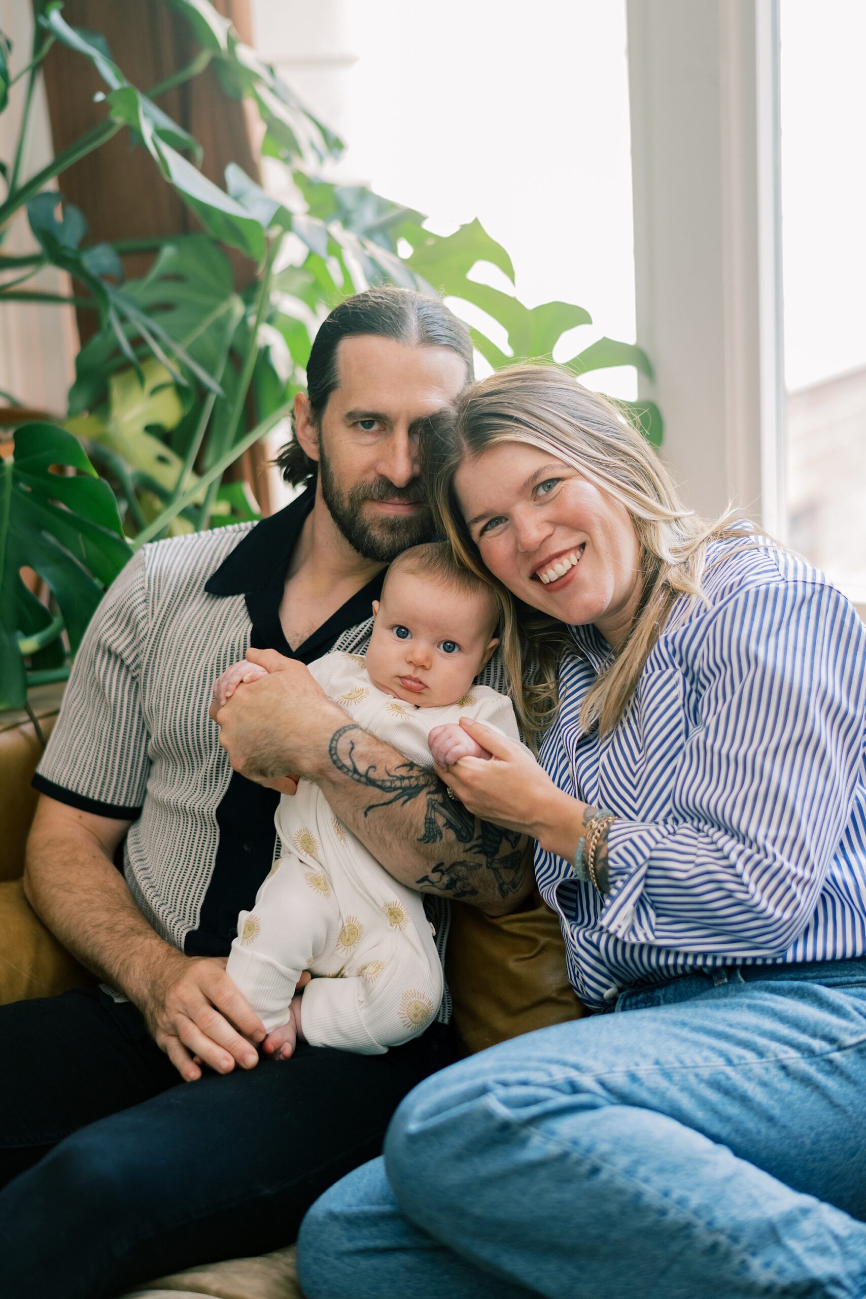 parents snuggle with daughter during newborn session in Washington DC home