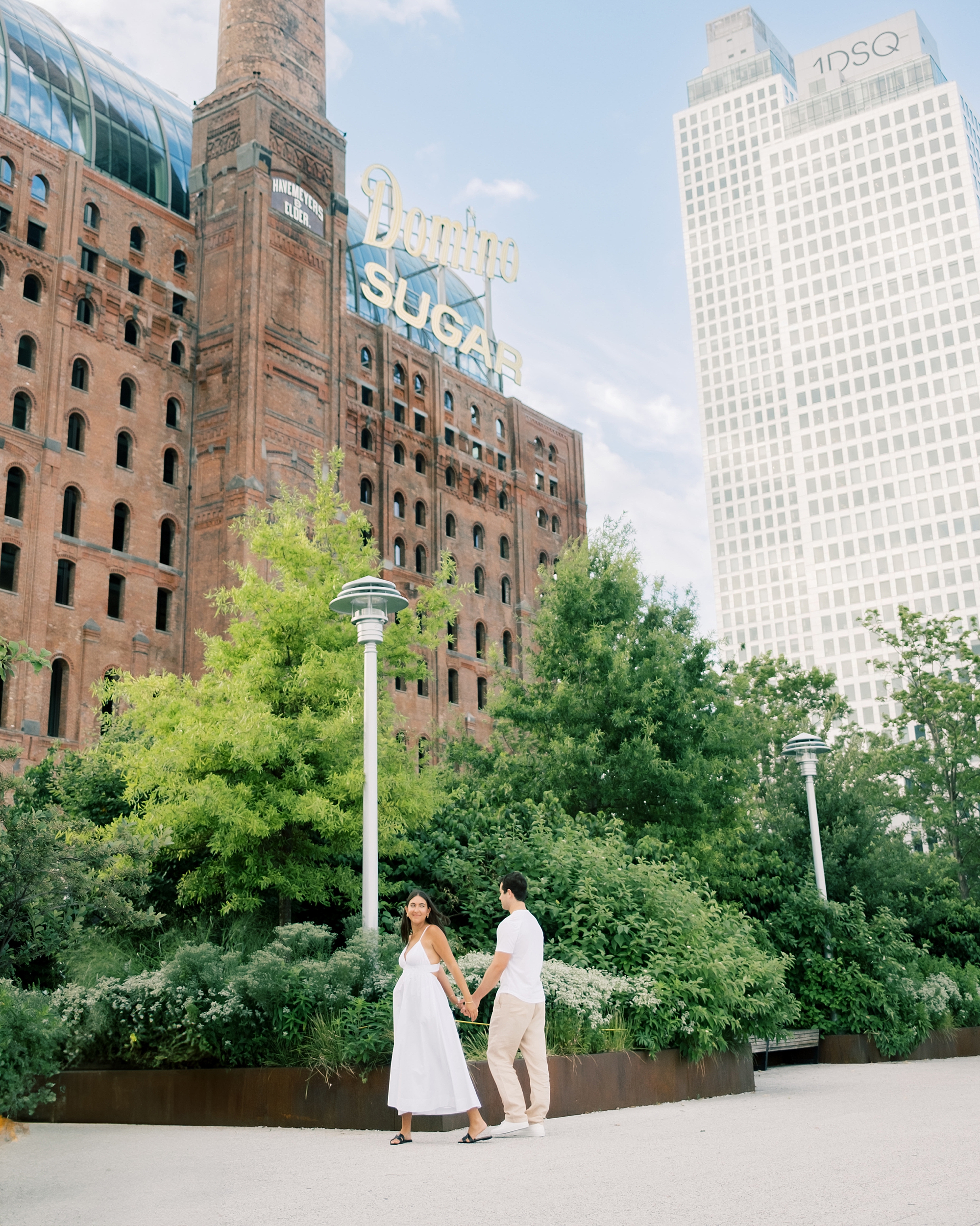 engaged couple walks through Williamsburg NYC