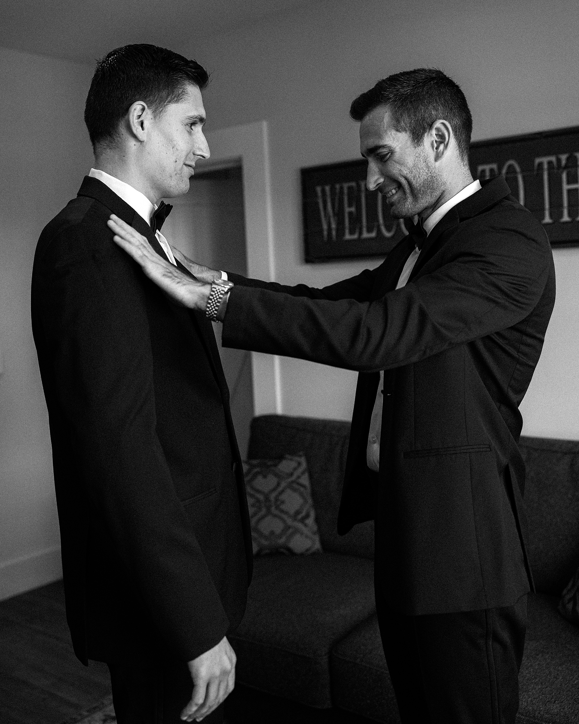 groomsman helps groom with suit jacket at Chesapeake Bay Beach Club