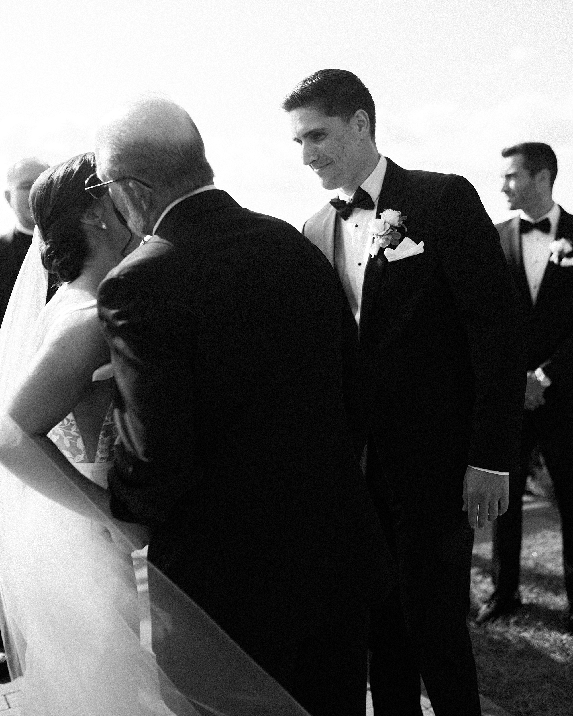 father kisses bride's cheek before ceremony at Chesapeake Bay Beach Club