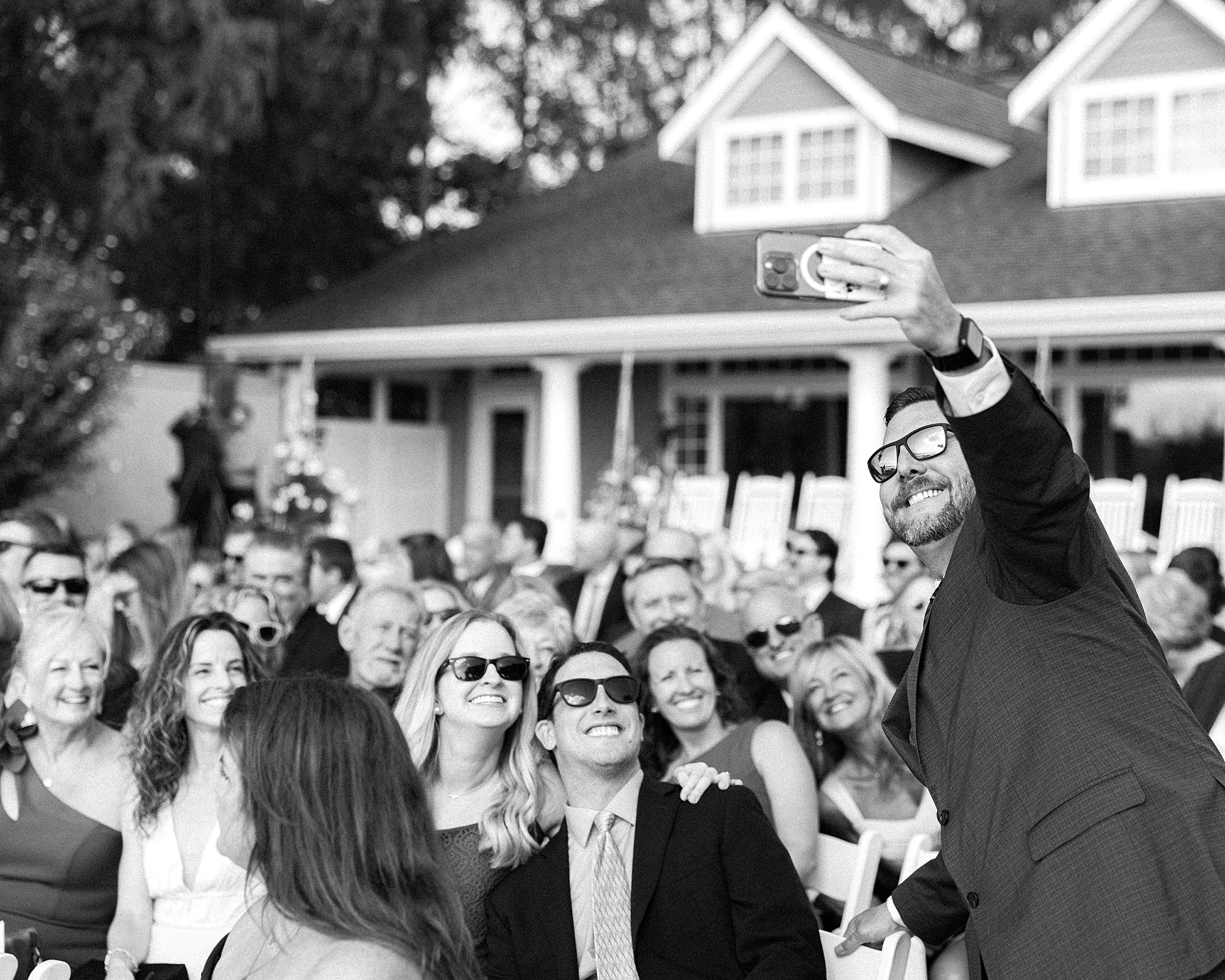 wedding guest takes selfie with ceremony guests