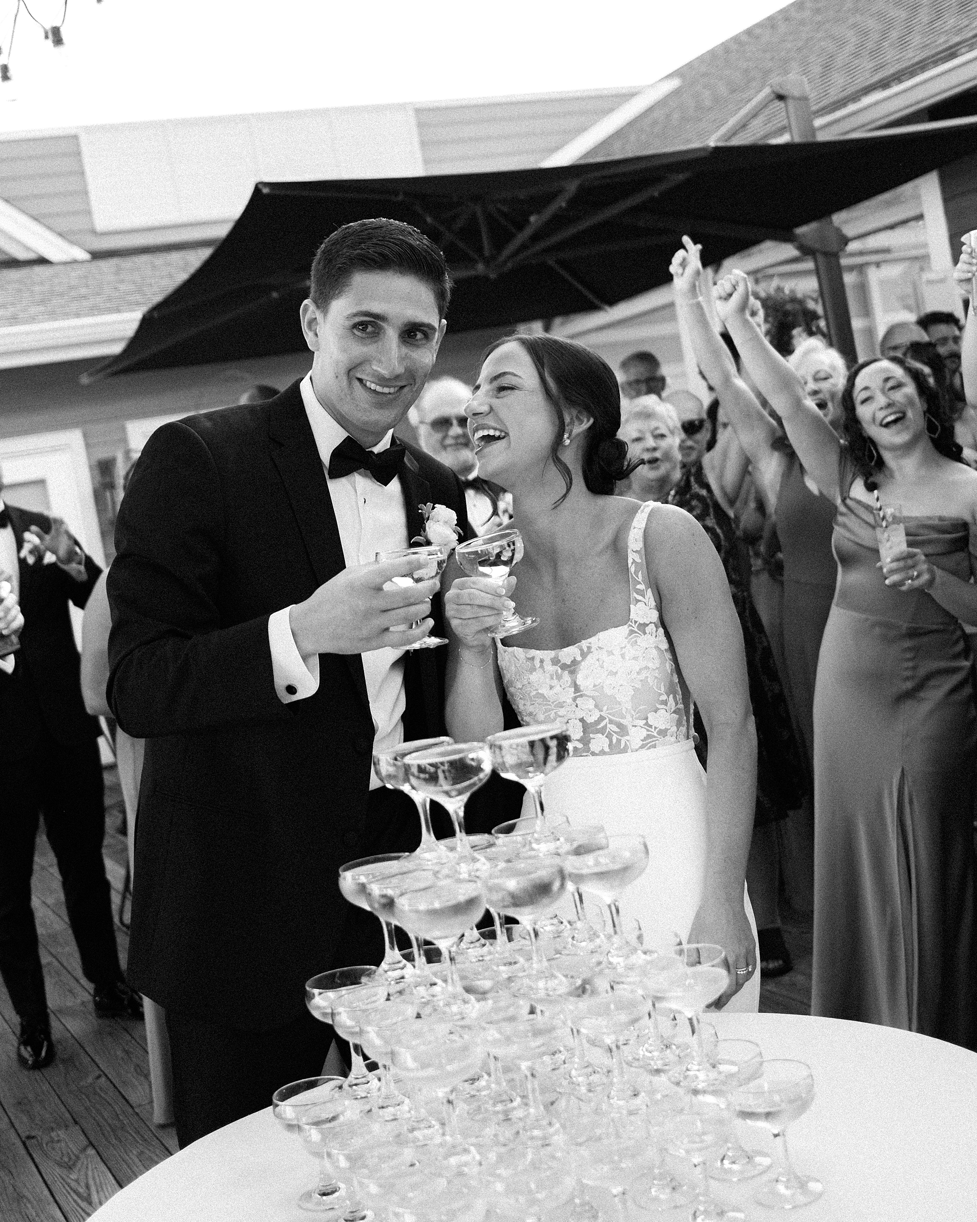 bride and groom grin during champagne tower