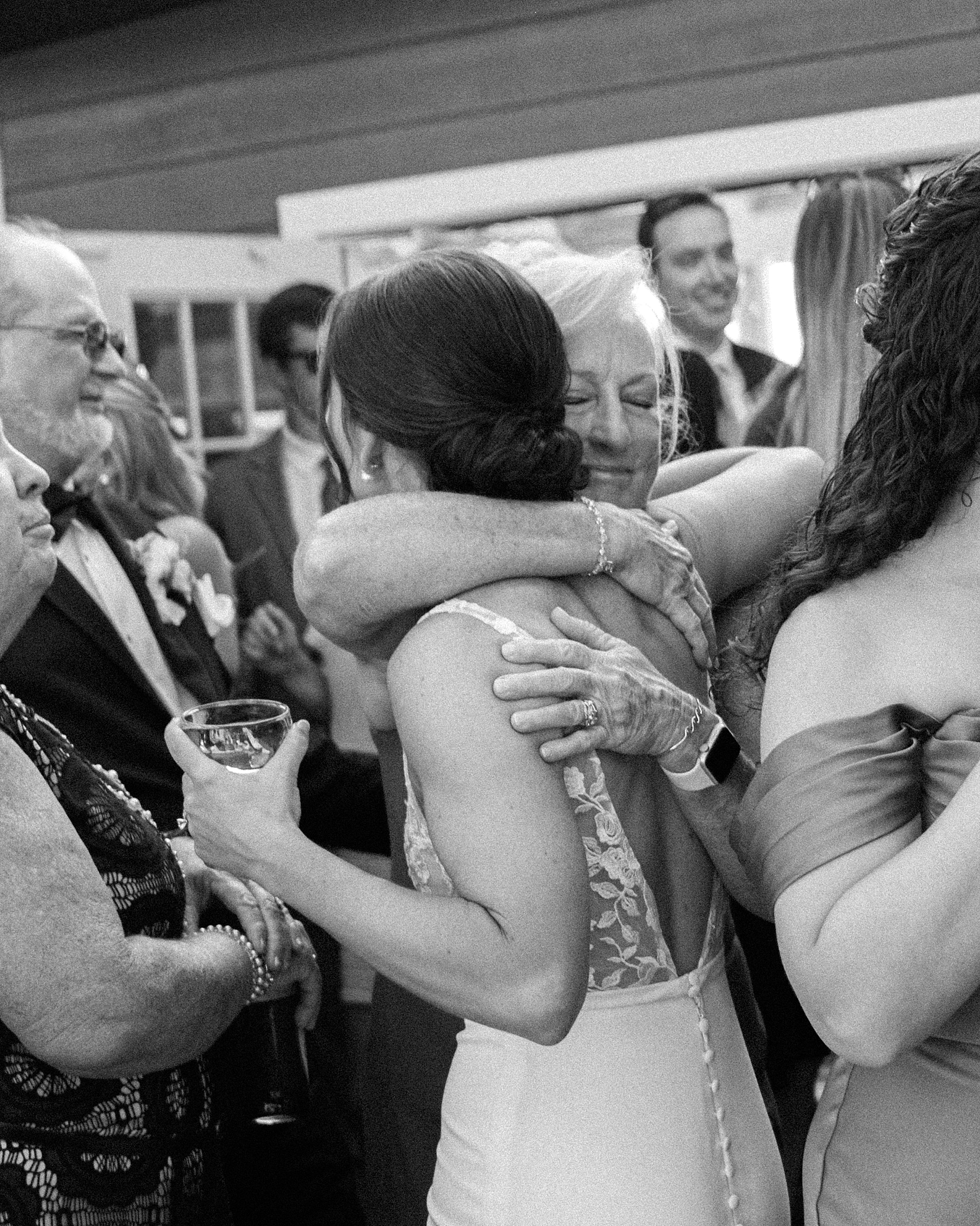 bride hugs guest after entering wedding reception