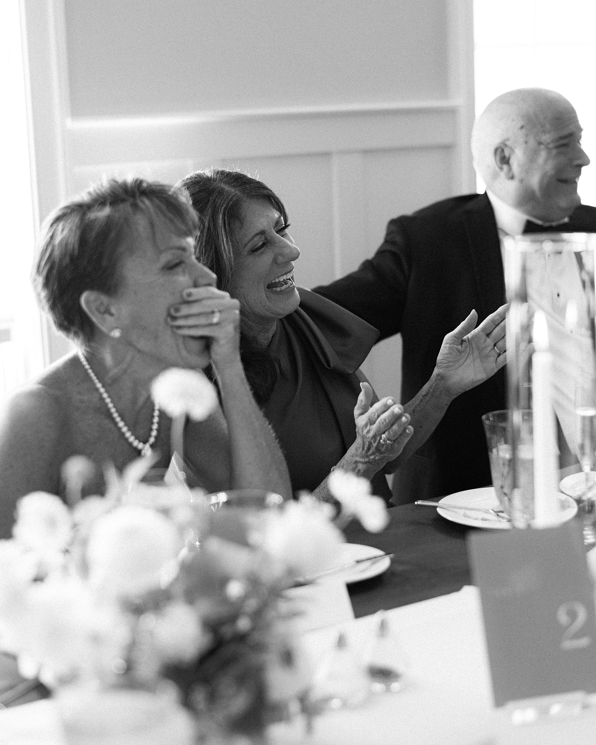 wedding guests laugh during toasts at Chesapeake Bay Beach Club