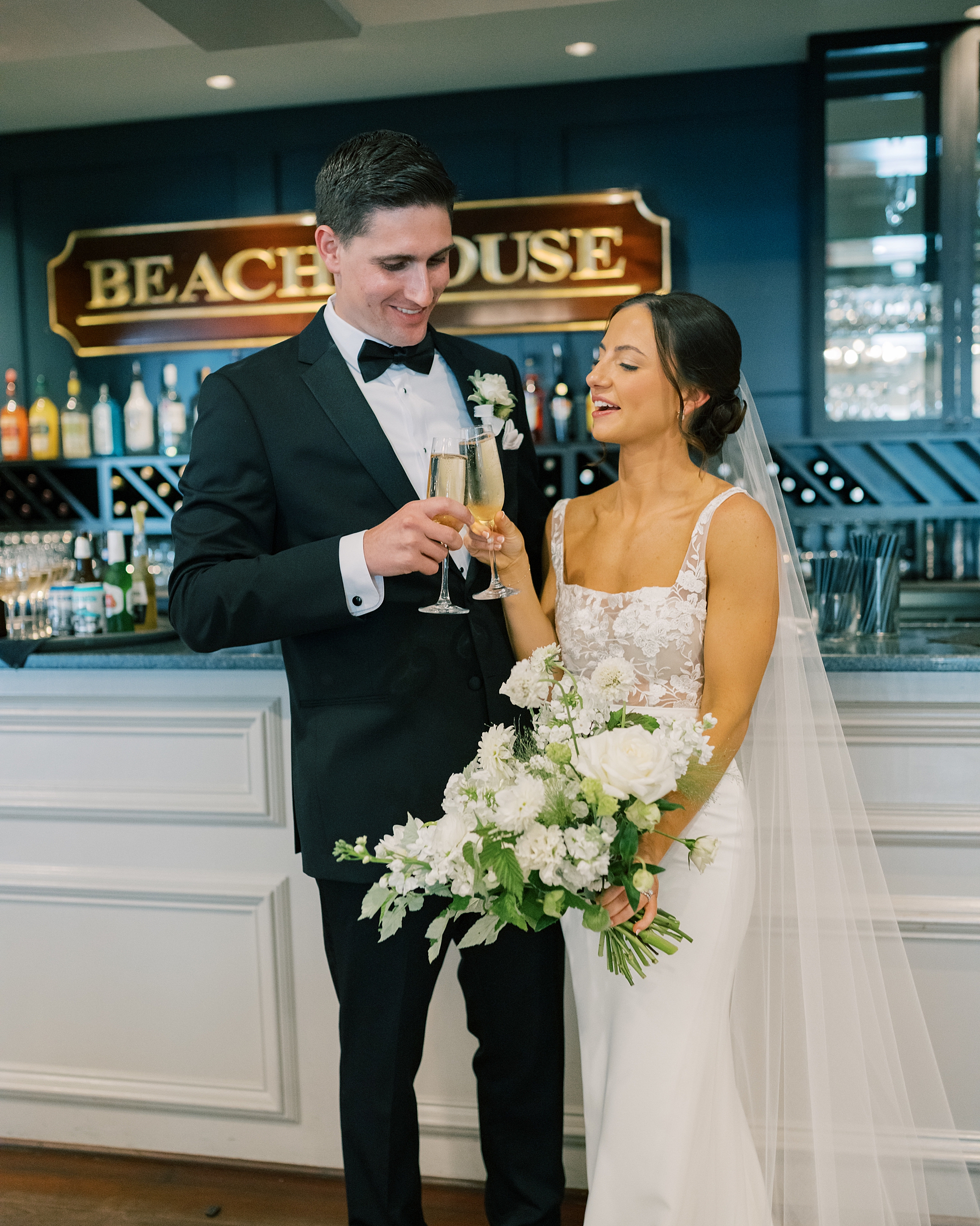 bride and groom toast champagne in Boathouse bar at Chesapeake Bay Beach Club