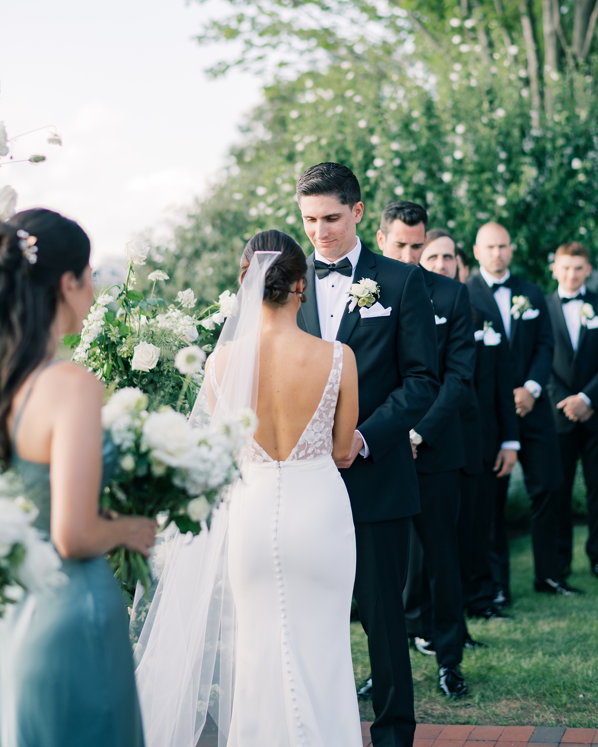 groom smiles at bride during wedding ceremony at Chesapeake Bay Beach Club