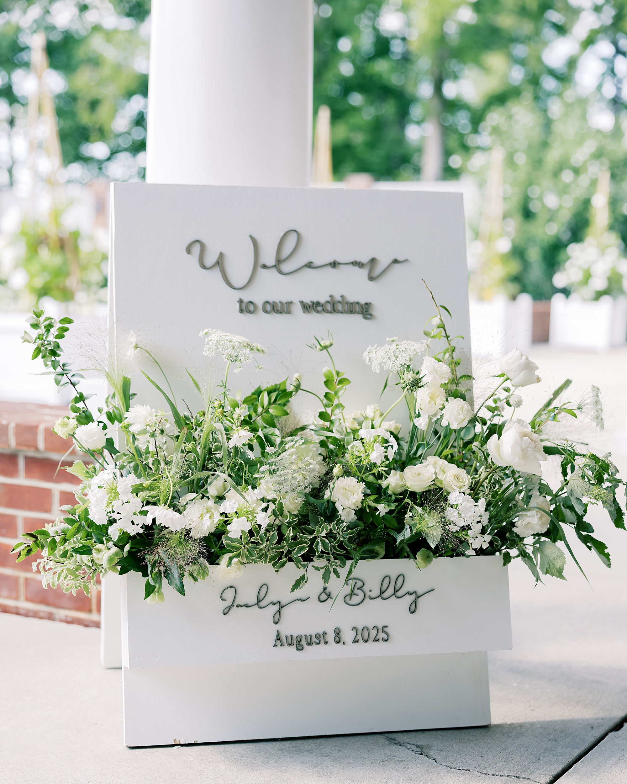 welcome sign with white flowers at Chesapeake Bay Beach Club