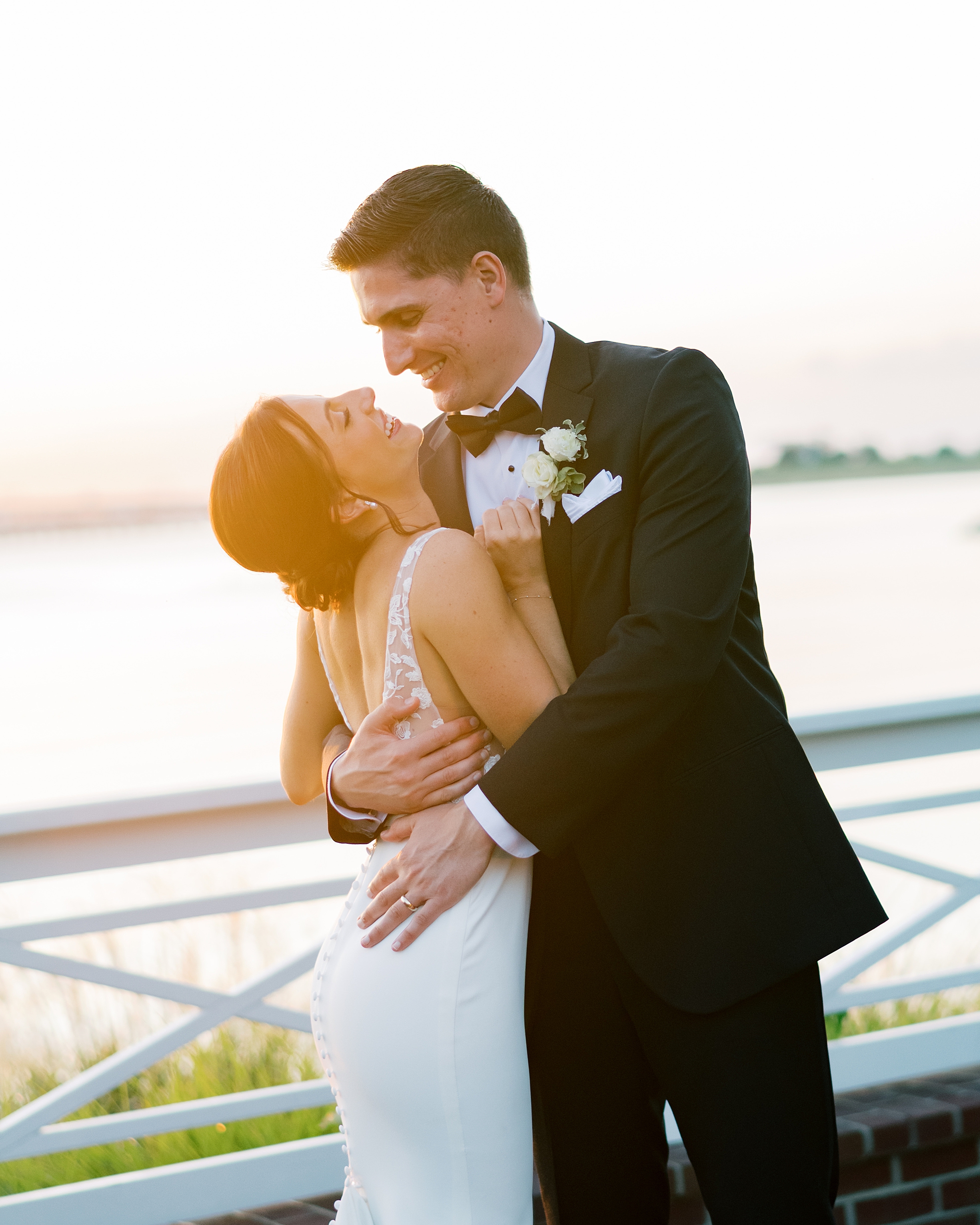 bride and groom pose on balcony at the Chesapeake Bay Beach Club