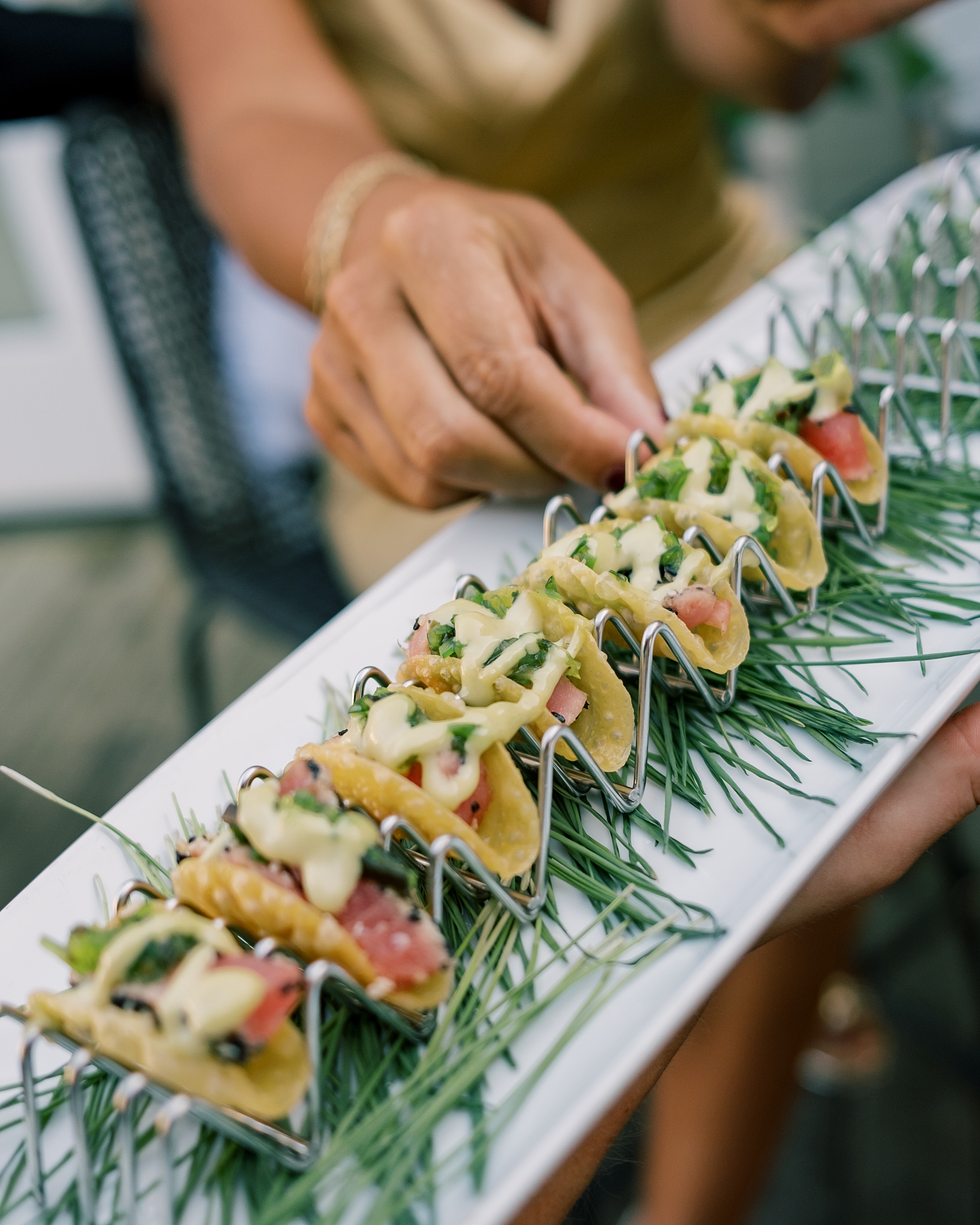 guest reaches for appetizer on white tray at Chesapeake Bay Beach Club