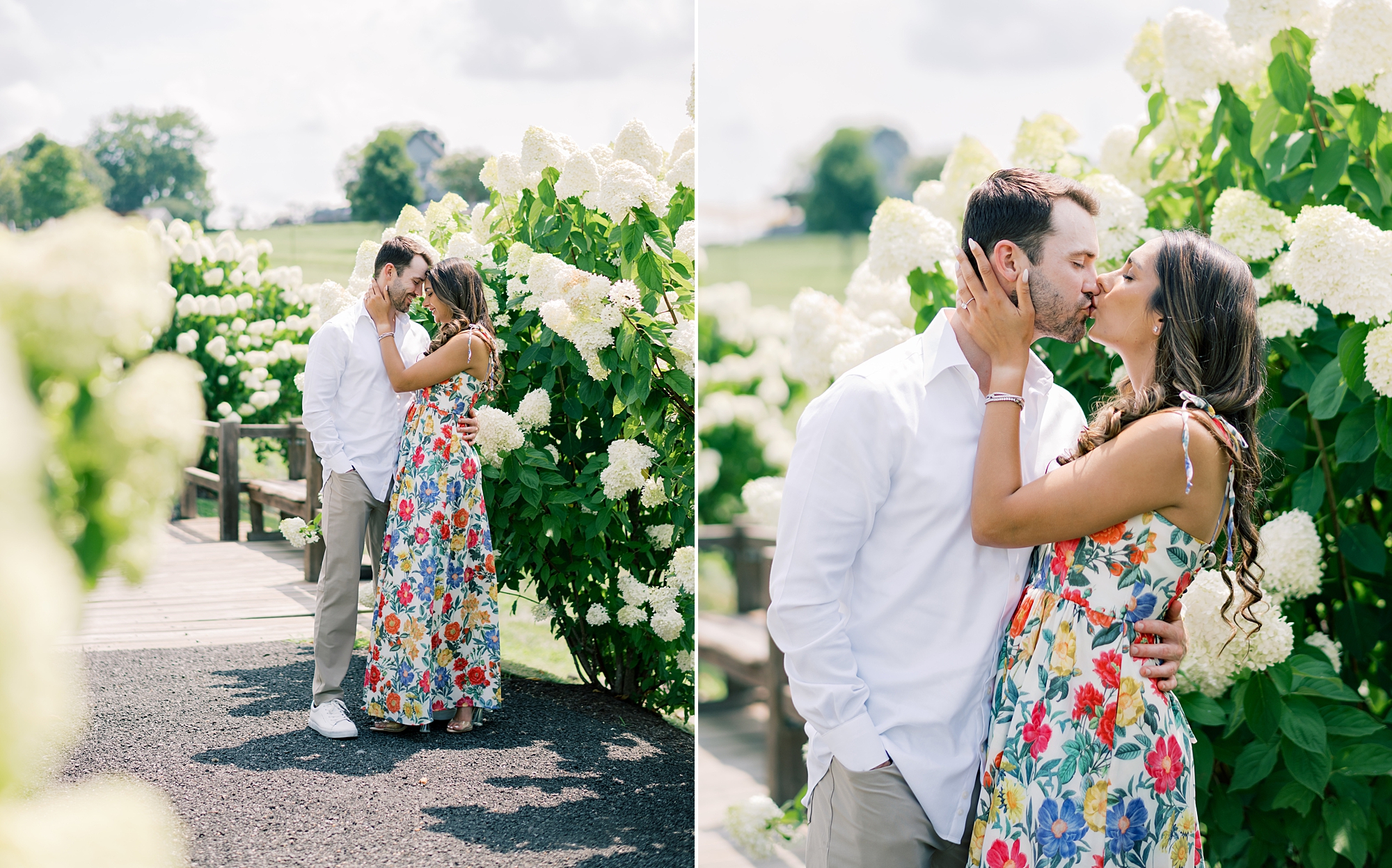 man and woman kiss hugging by white hydrangeas at Stone Tower Winery