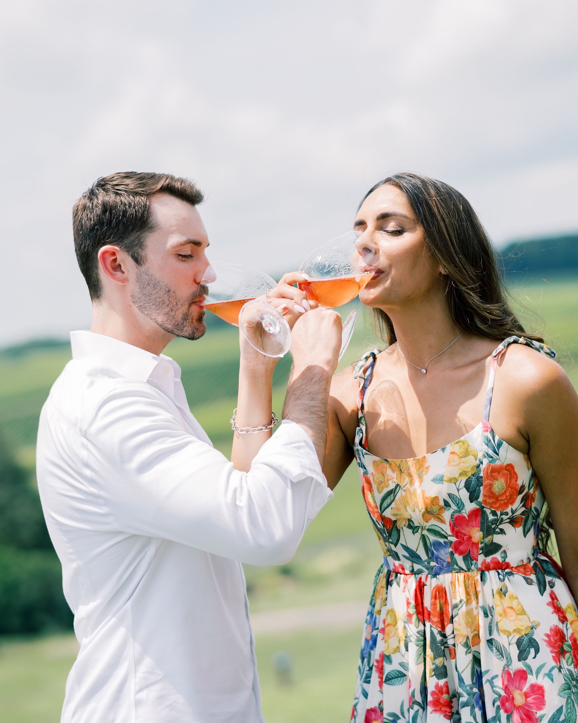 couple drinks wine with arms looped at Stone Tower Winery