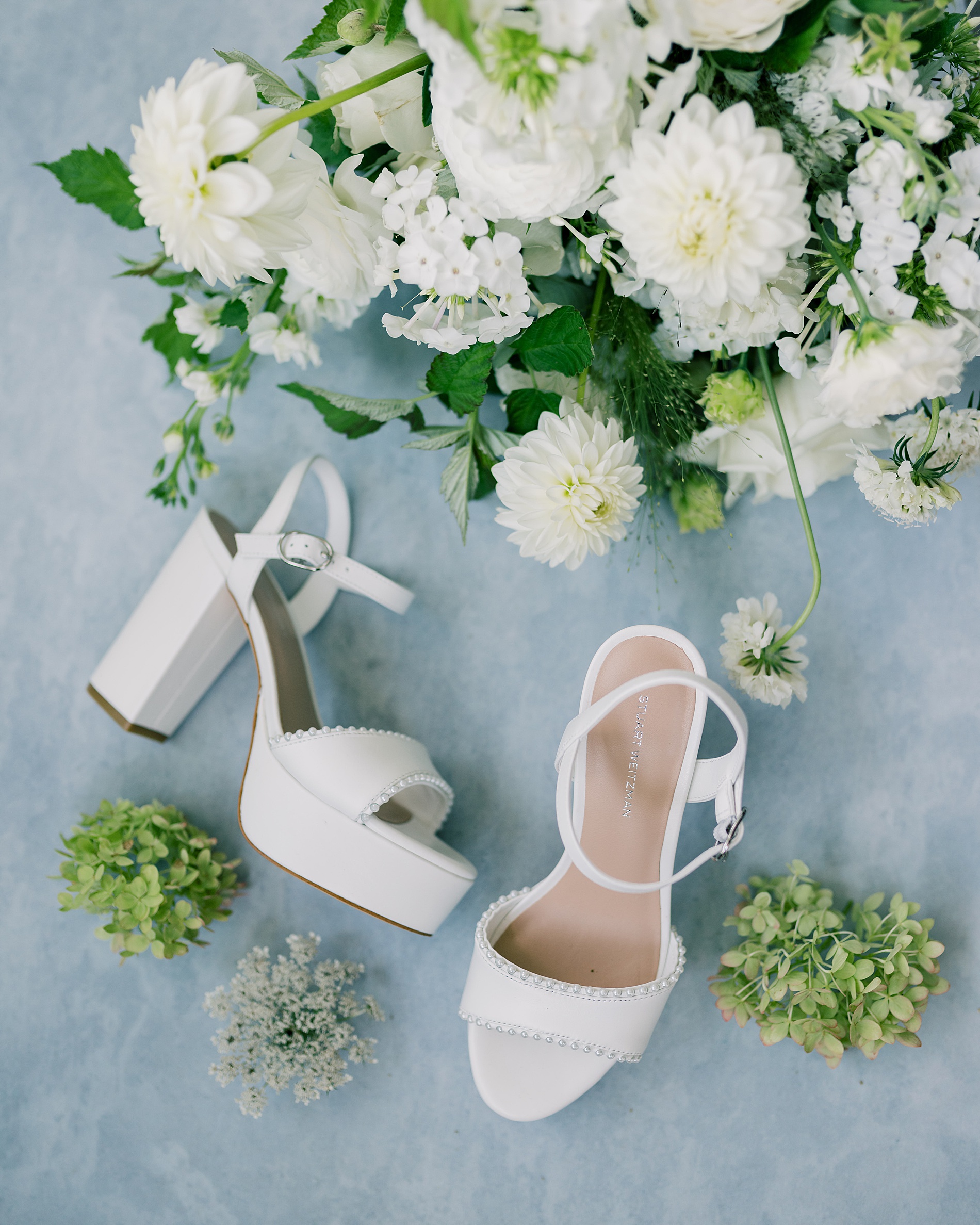 bride's wedding shoes and bouquet