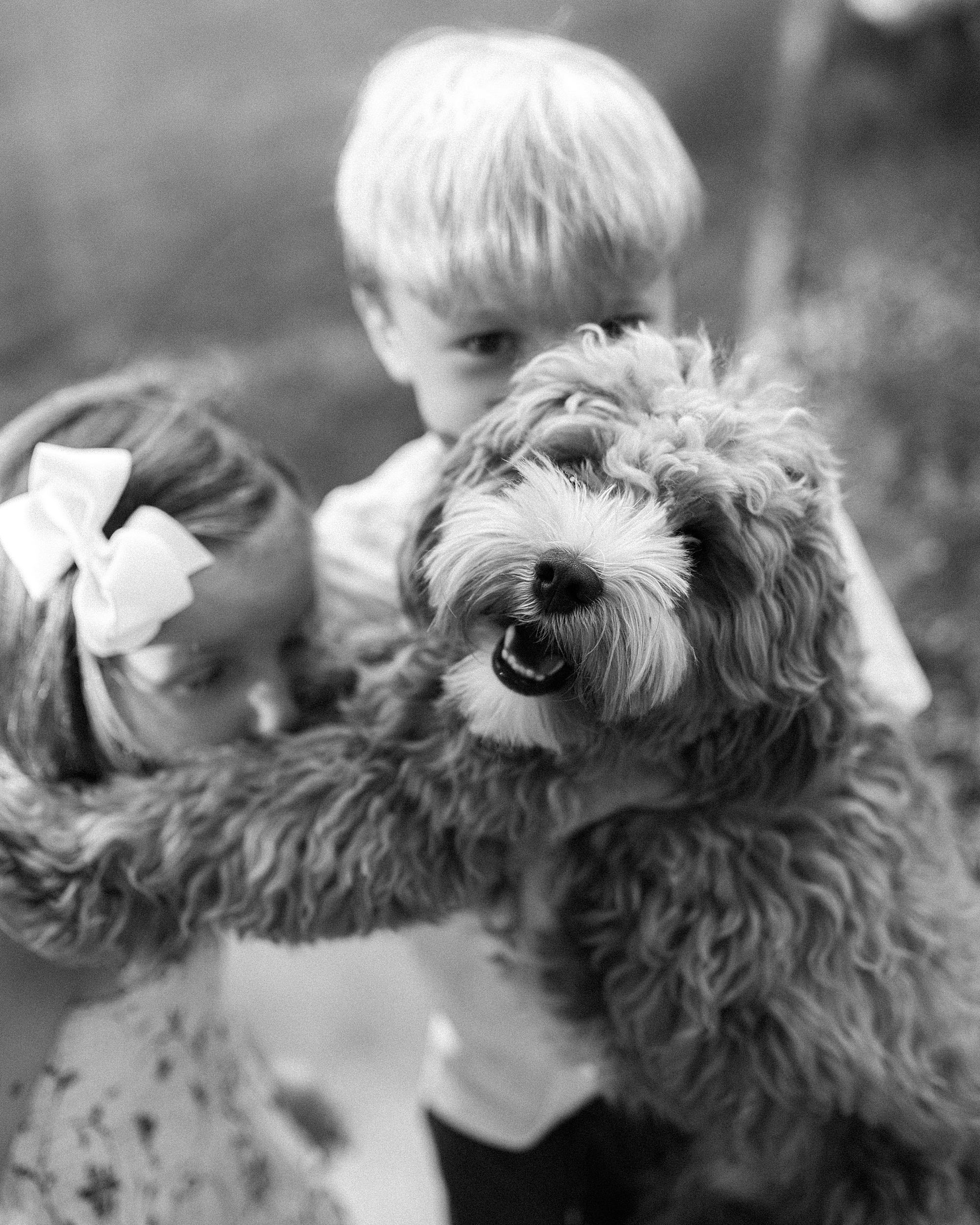 children hug their dog