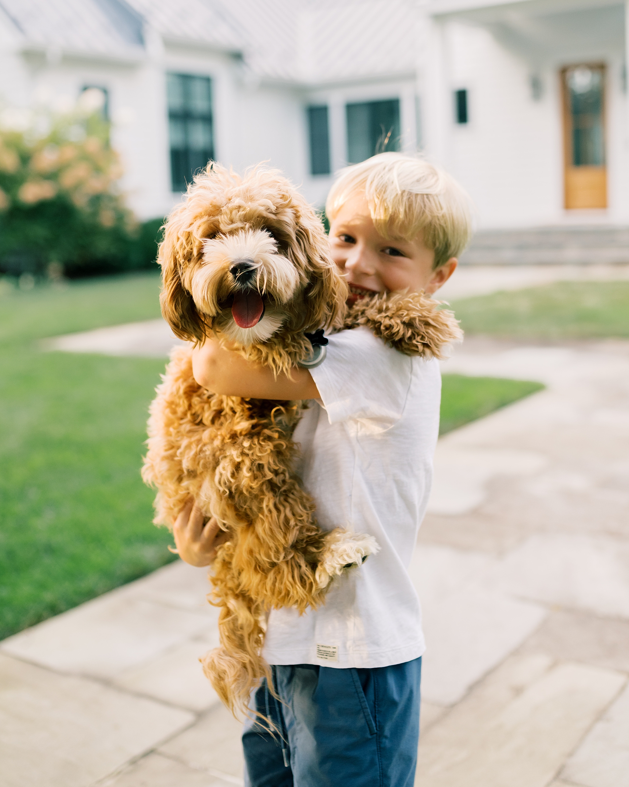 young boy holds family dog