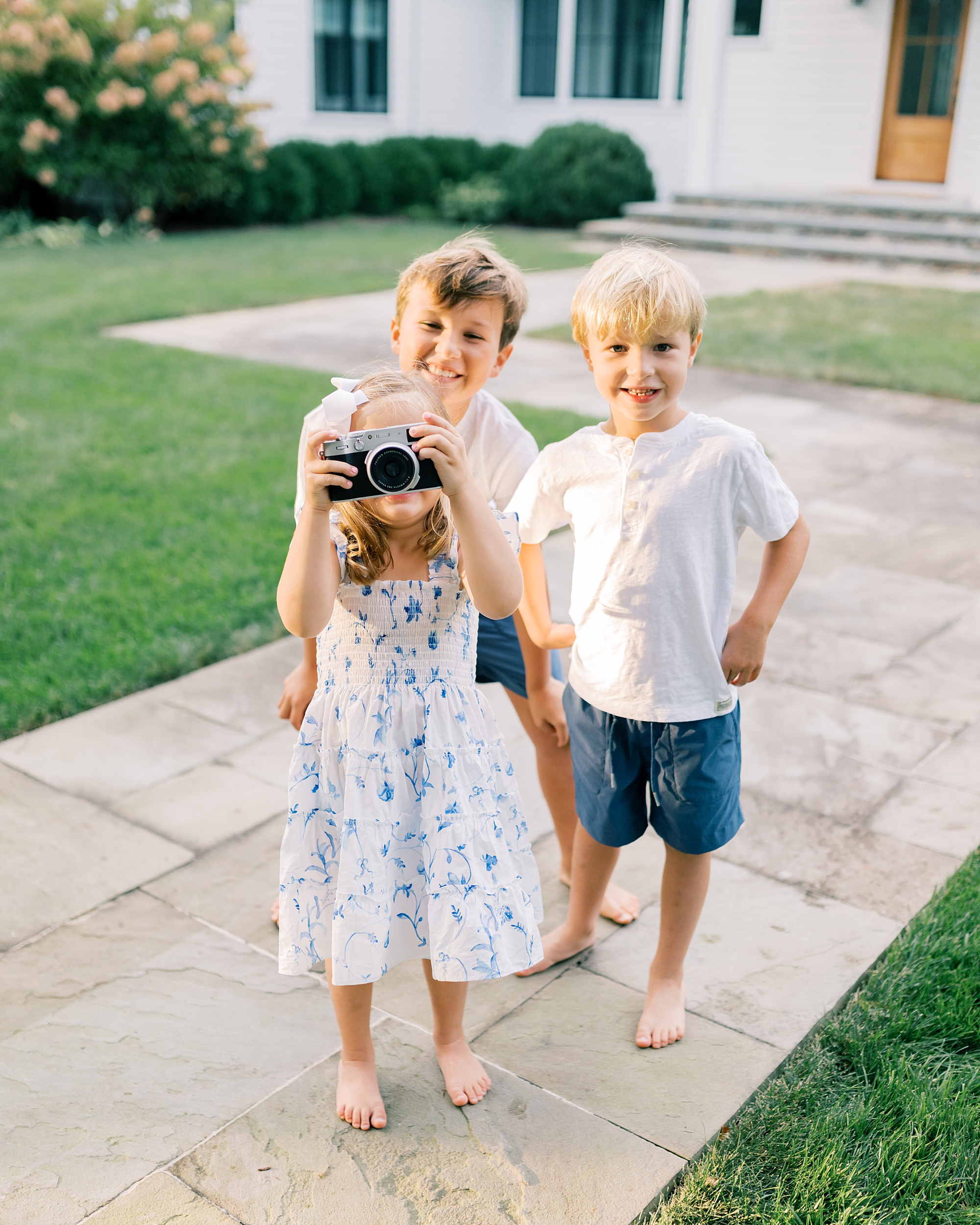 three kids play with fuji camera 