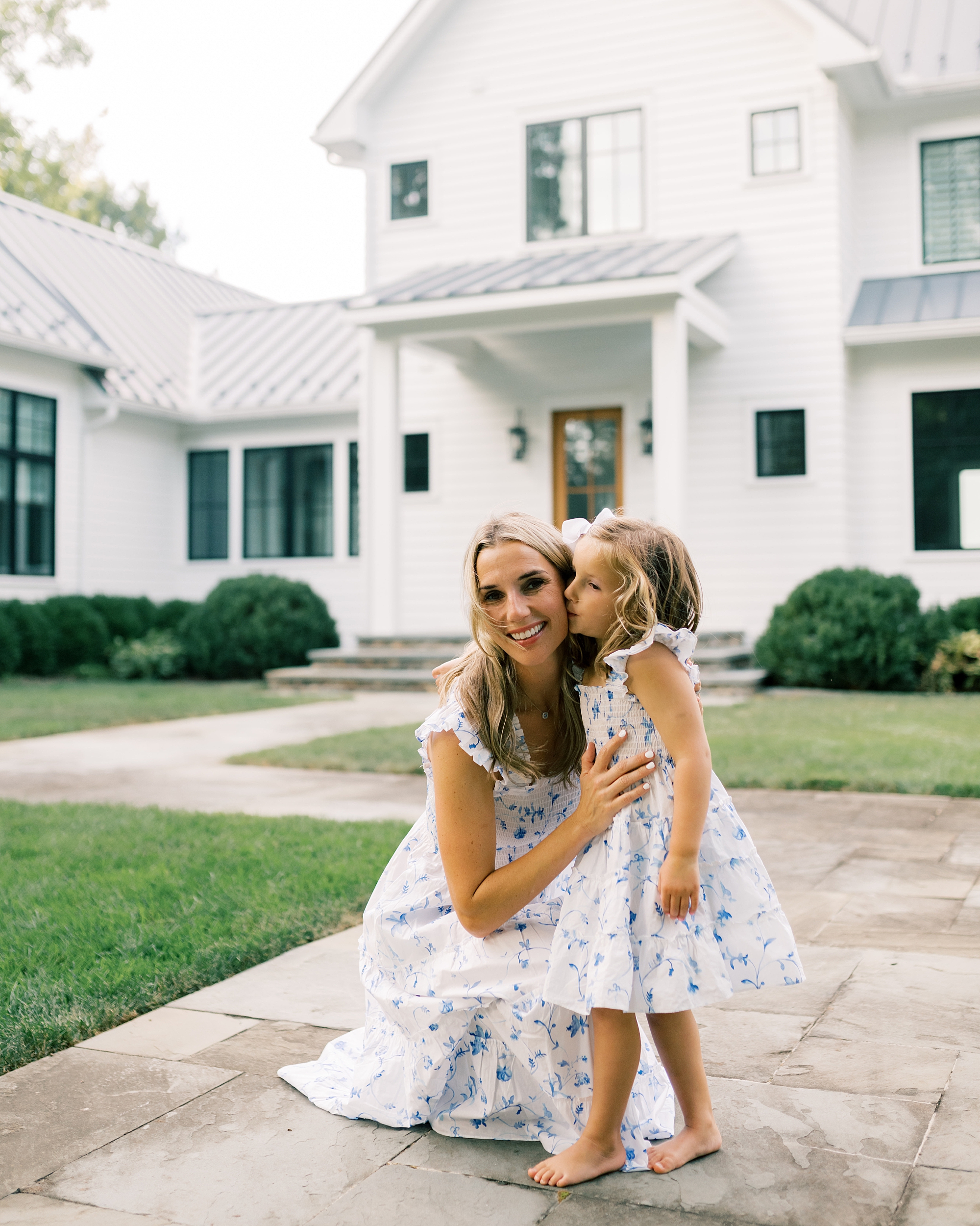 mom and daughter outside of family home