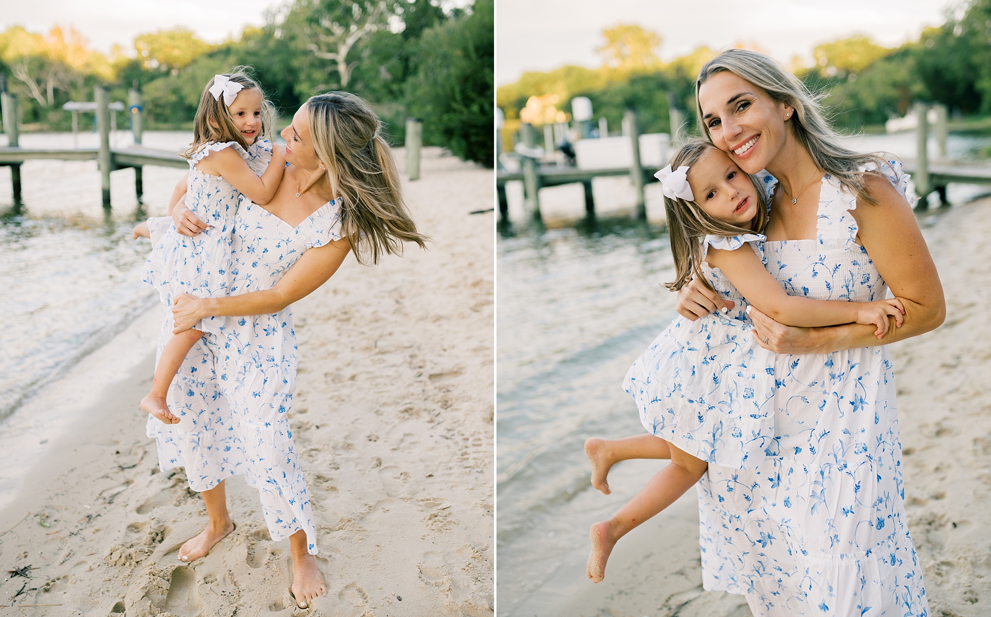 mom holds daughter in arms on beach area by the water
