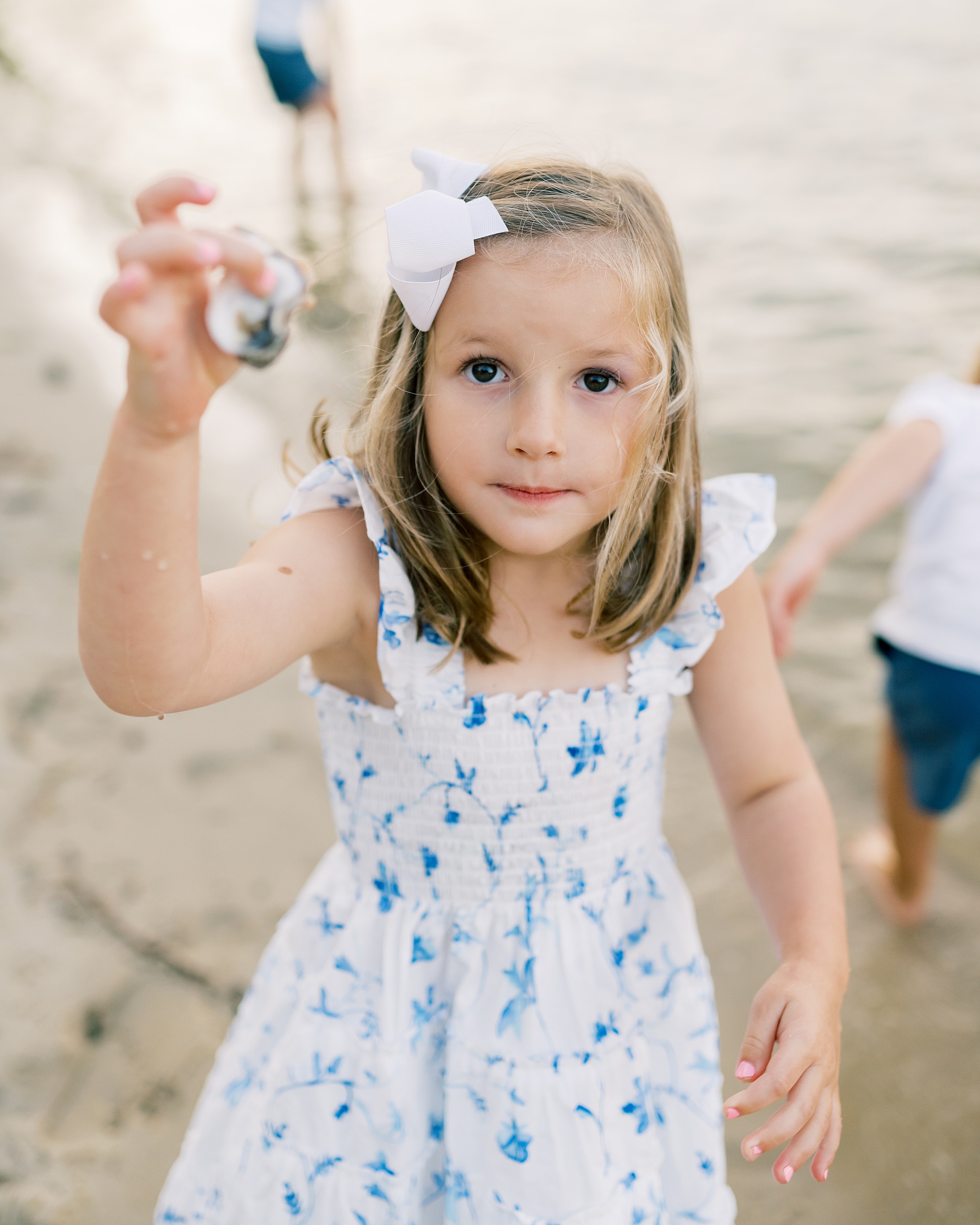 little girl holds up shell
