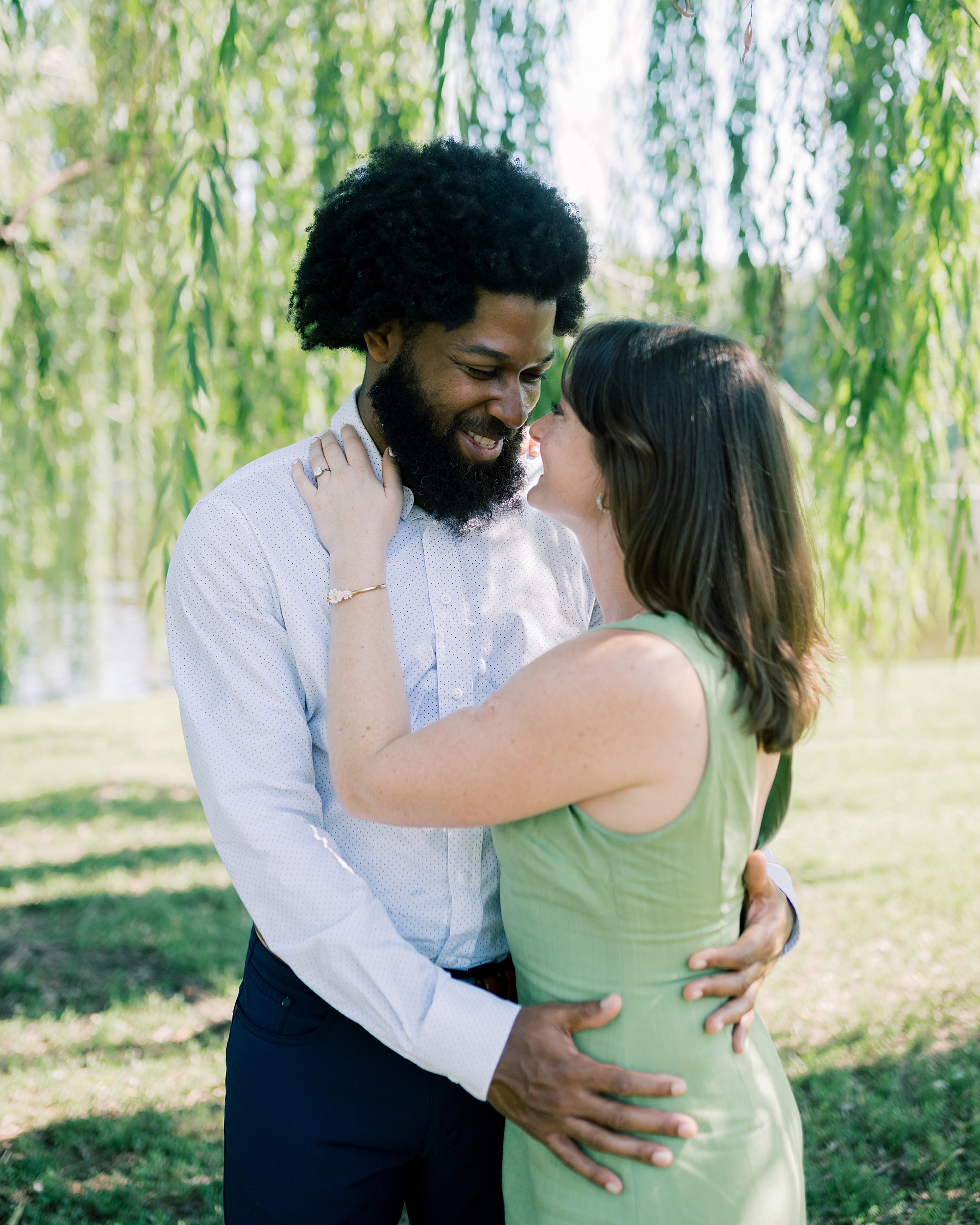 Romantic engagement photos under weeping willow tree