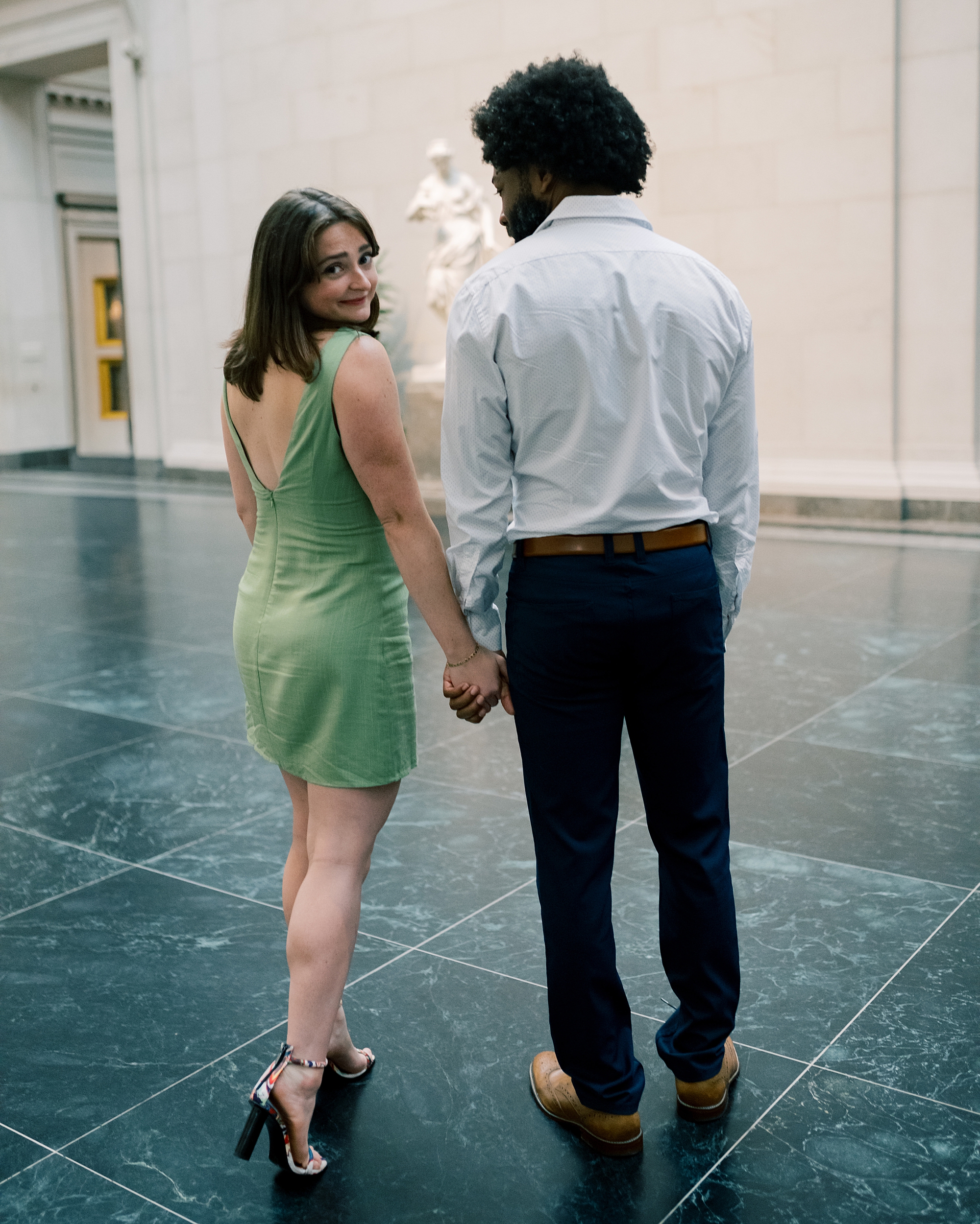 couple by statue at art museum 