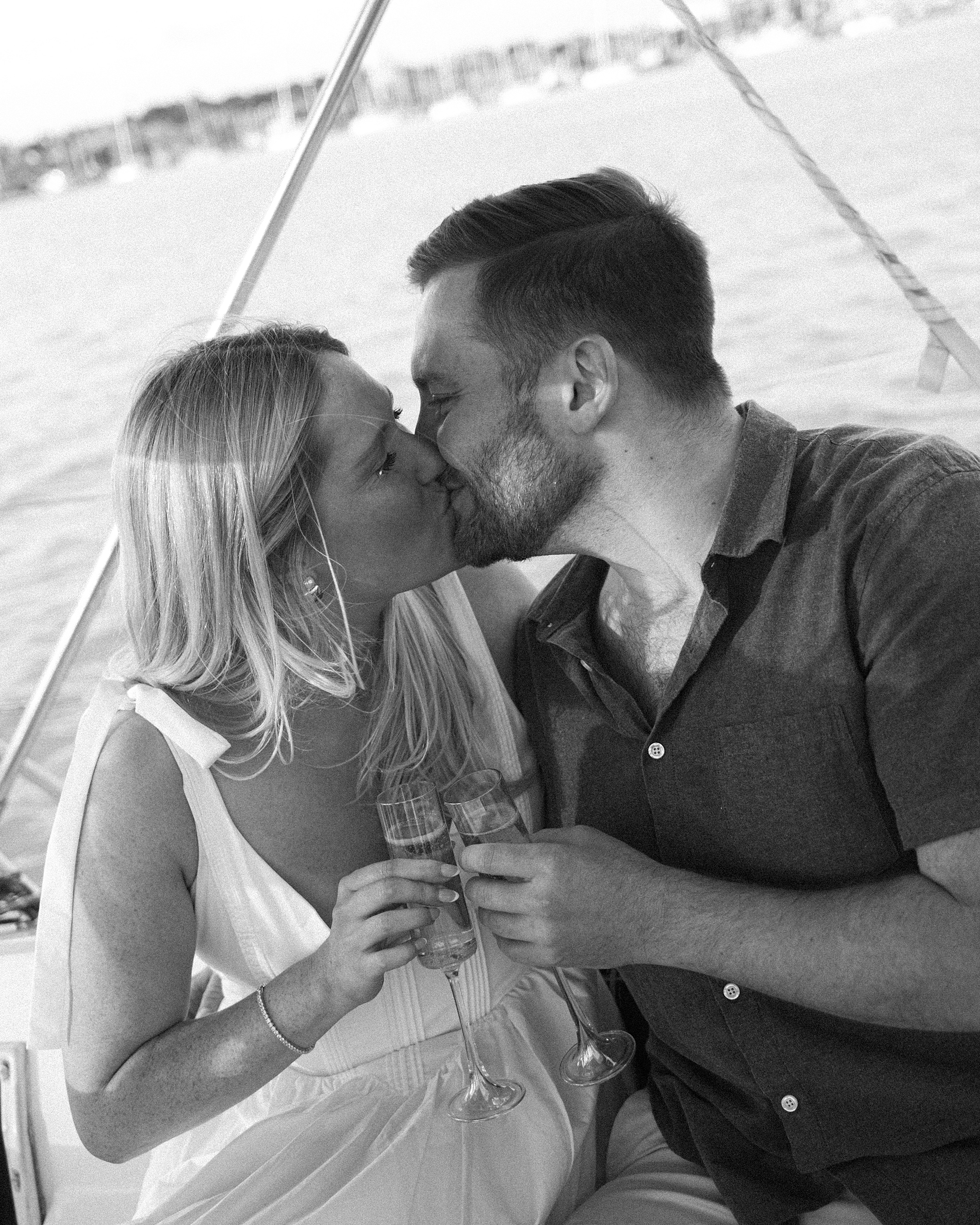 couple kiss while toasting champagne 