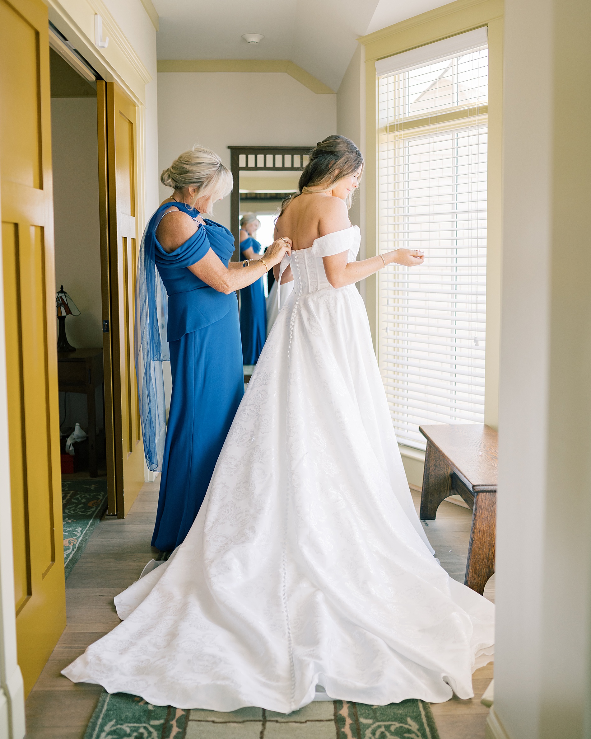 bride gets into wedding dress