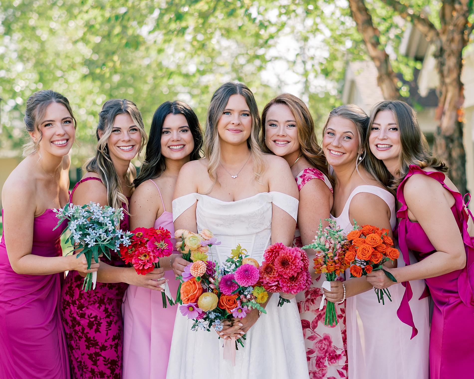 bridesmaids in colorful dresses with bride