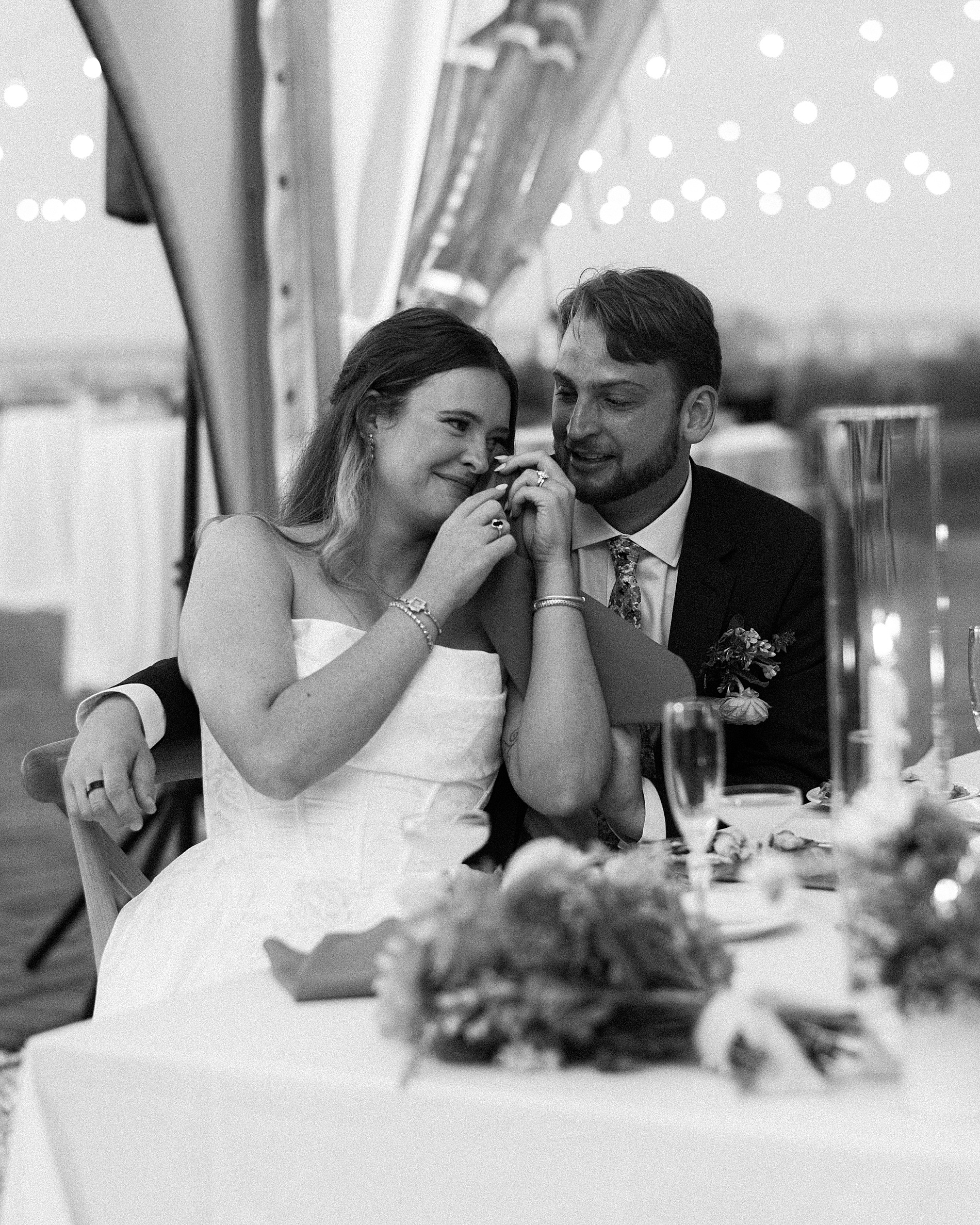 bride wipes away tears during wedding toasts