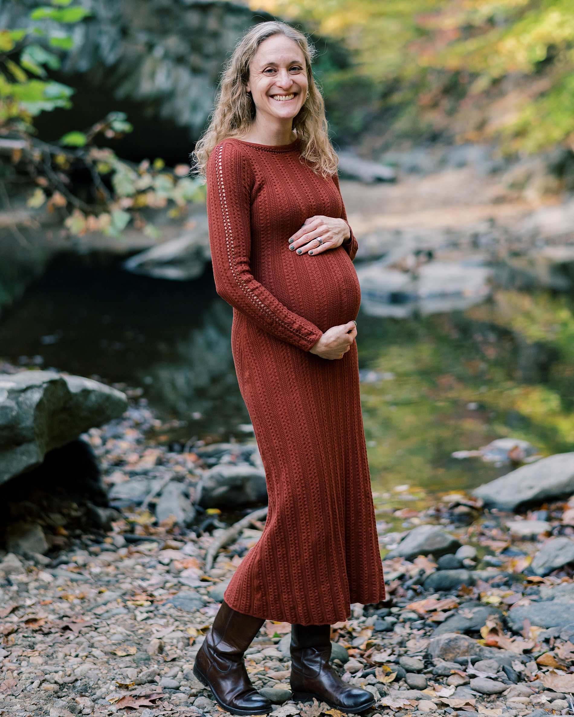 mom holds baby bump during maternity portraits 