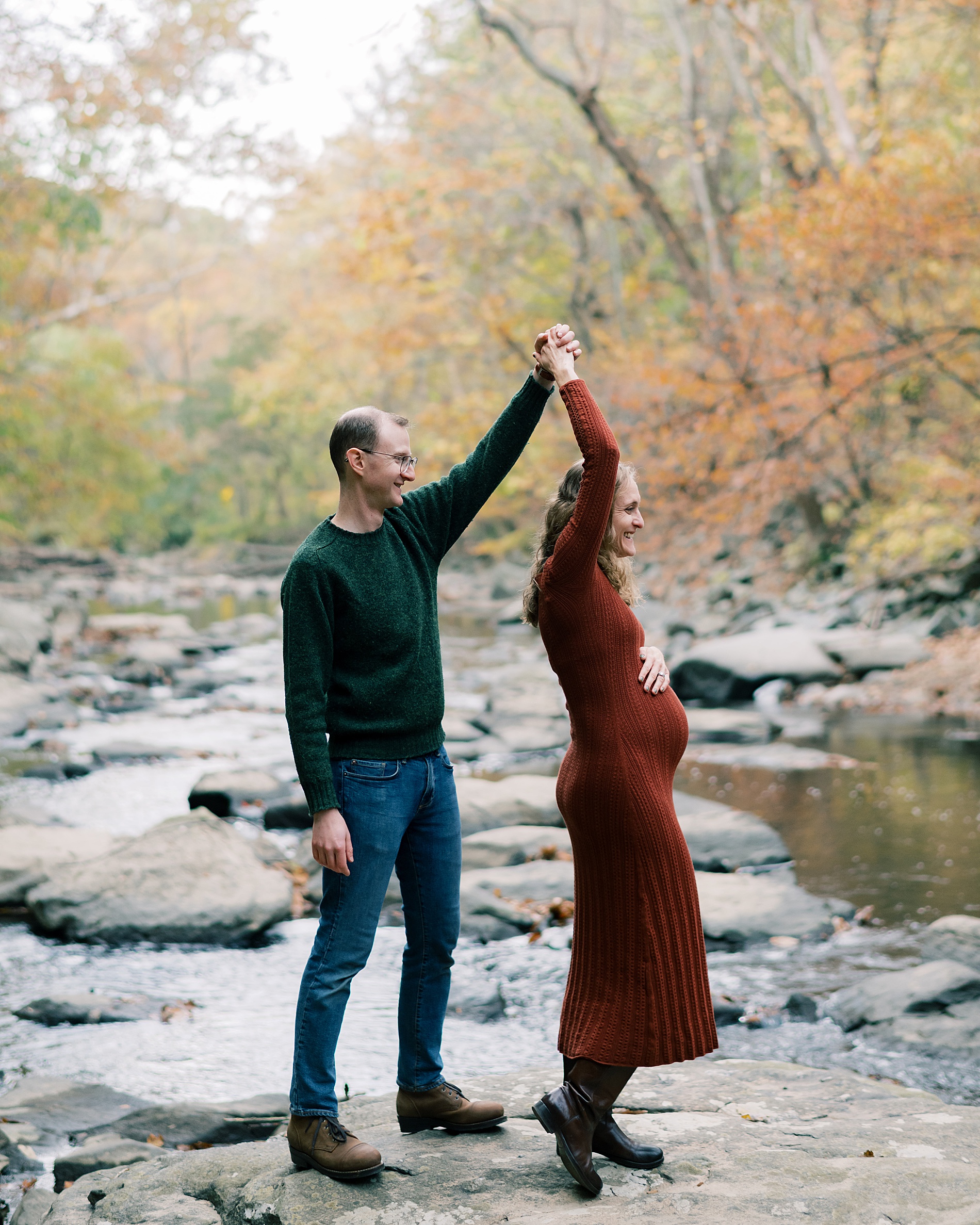 couple twirl in creek bed in Washington DC park
