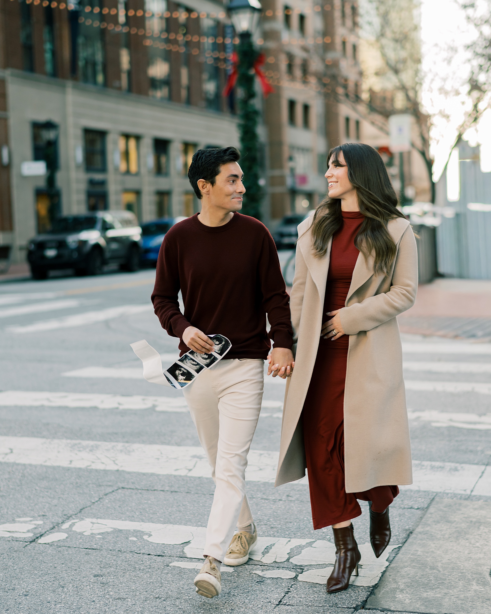 expectant parents walk across street in Baltimore