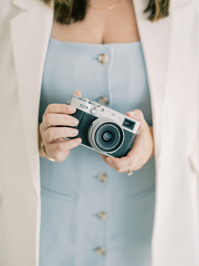 Photographer holding a Fujifilm Camera