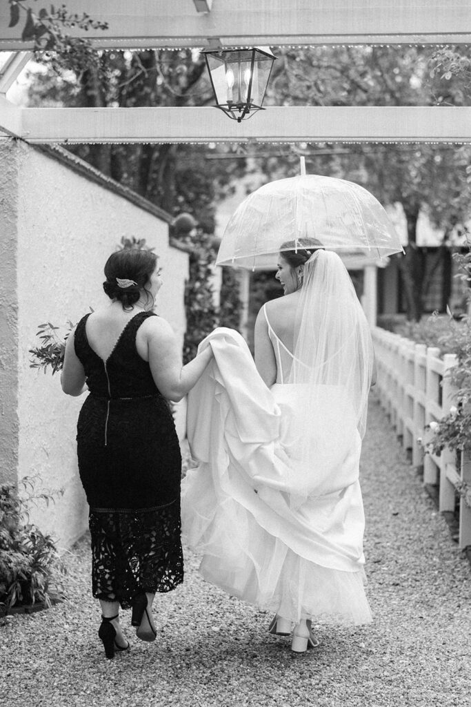 bride and bridesmaid on a rainy wedding day 