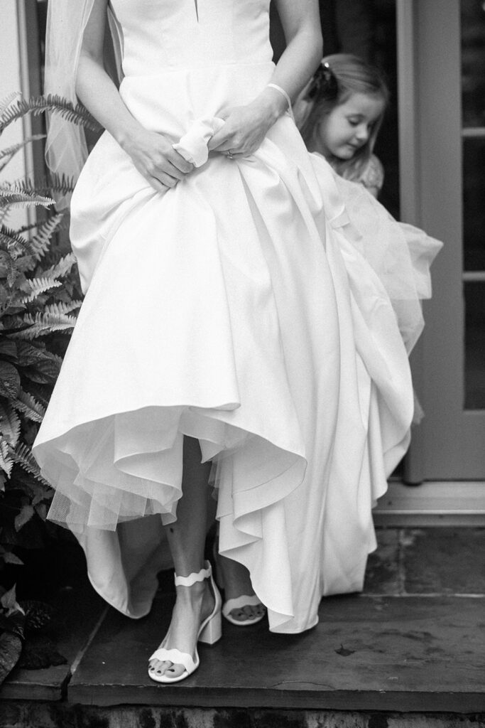 bride's gown and heels walking down stairs 