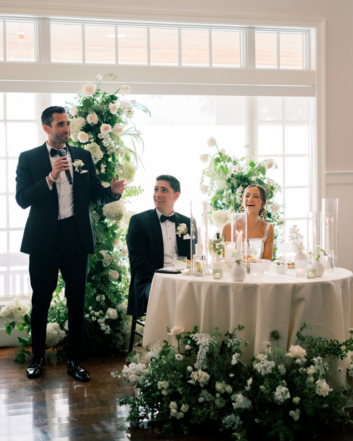 The groomsman gives a toast at the reception of a Chesapeake bay beach club wedding 