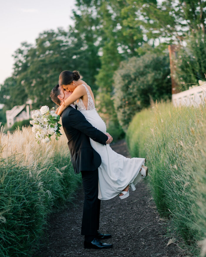 bride and groom share a kiss during portrait session 